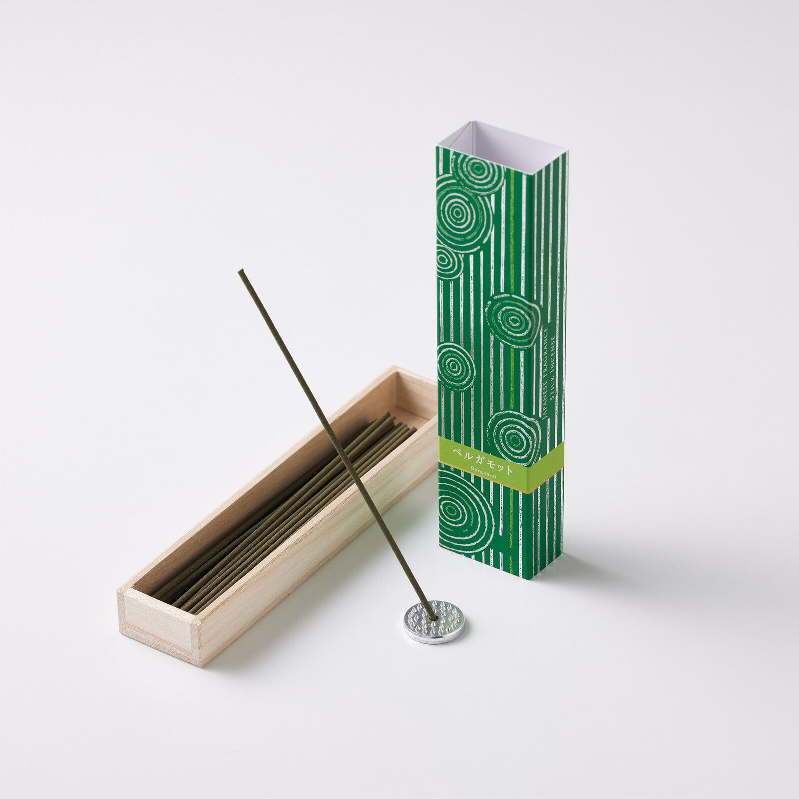Hyakuranko Bergamot Incense Stick displayed upright with holder, featuring elegant green packaging and natural wood case.