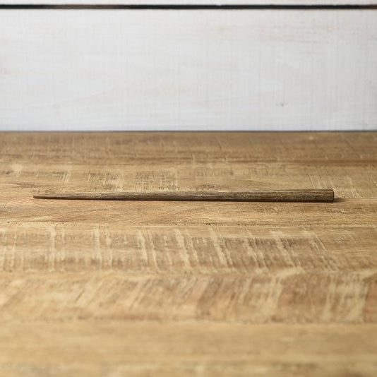Single pair of Kawai Tetoca Chopsticks - Persimmon Wood laid flat on rustic wooden surface, highlighting natural finish and slim profile.