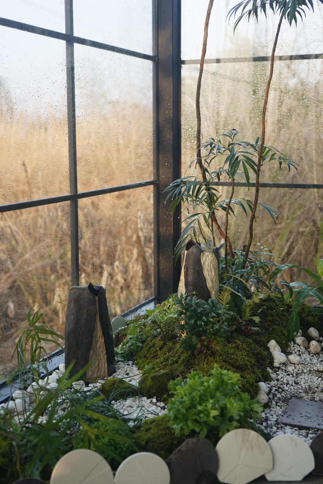 Lonesome Studio Mountain Form Flower Vases displayed in a garden setting, blending nature-inspired design with lush greenery.