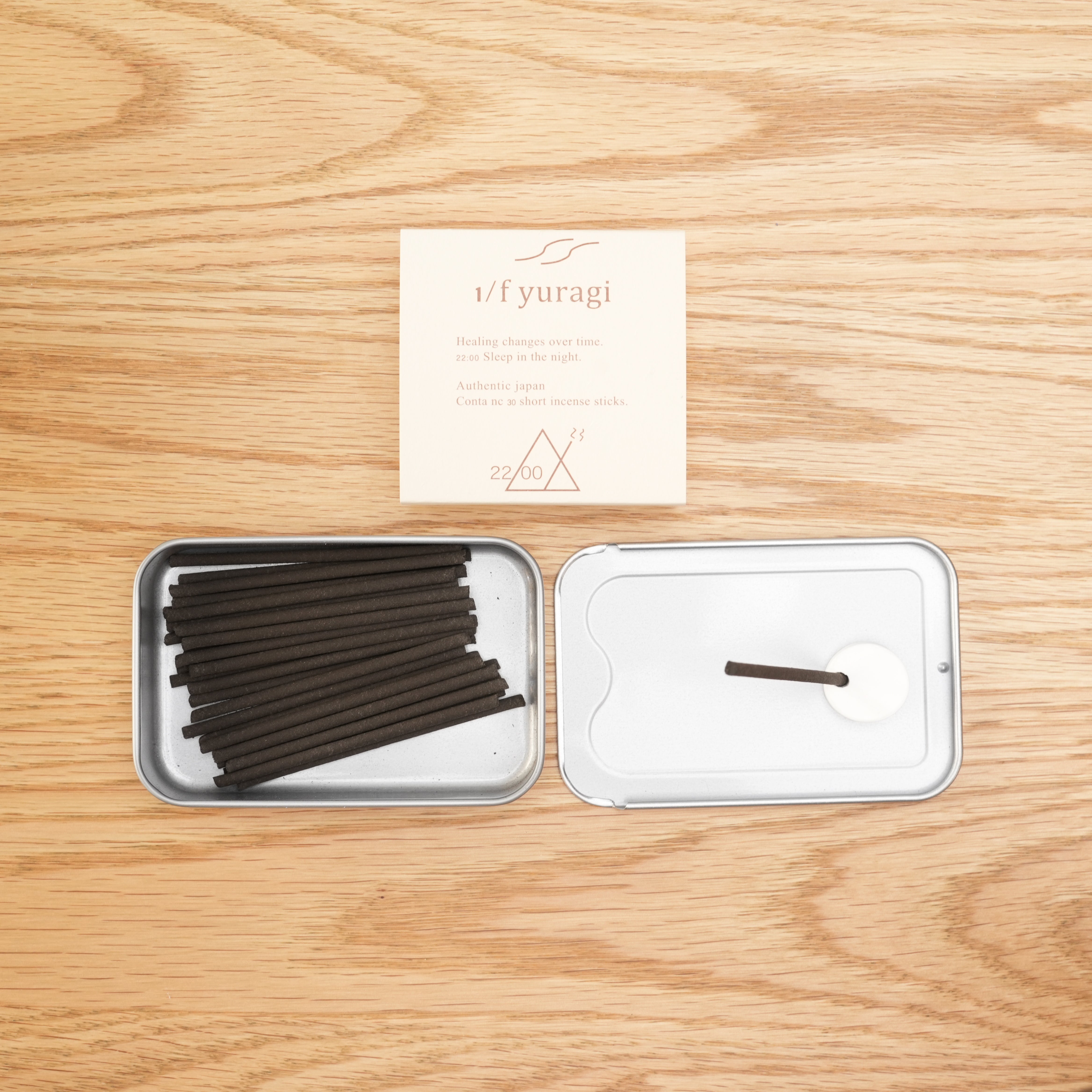 Open tin of 1/f Yuragi Incense 22:00 with black incense sticks and holder, perfect for 15-minute bedtime relaxation. Made in Japan.