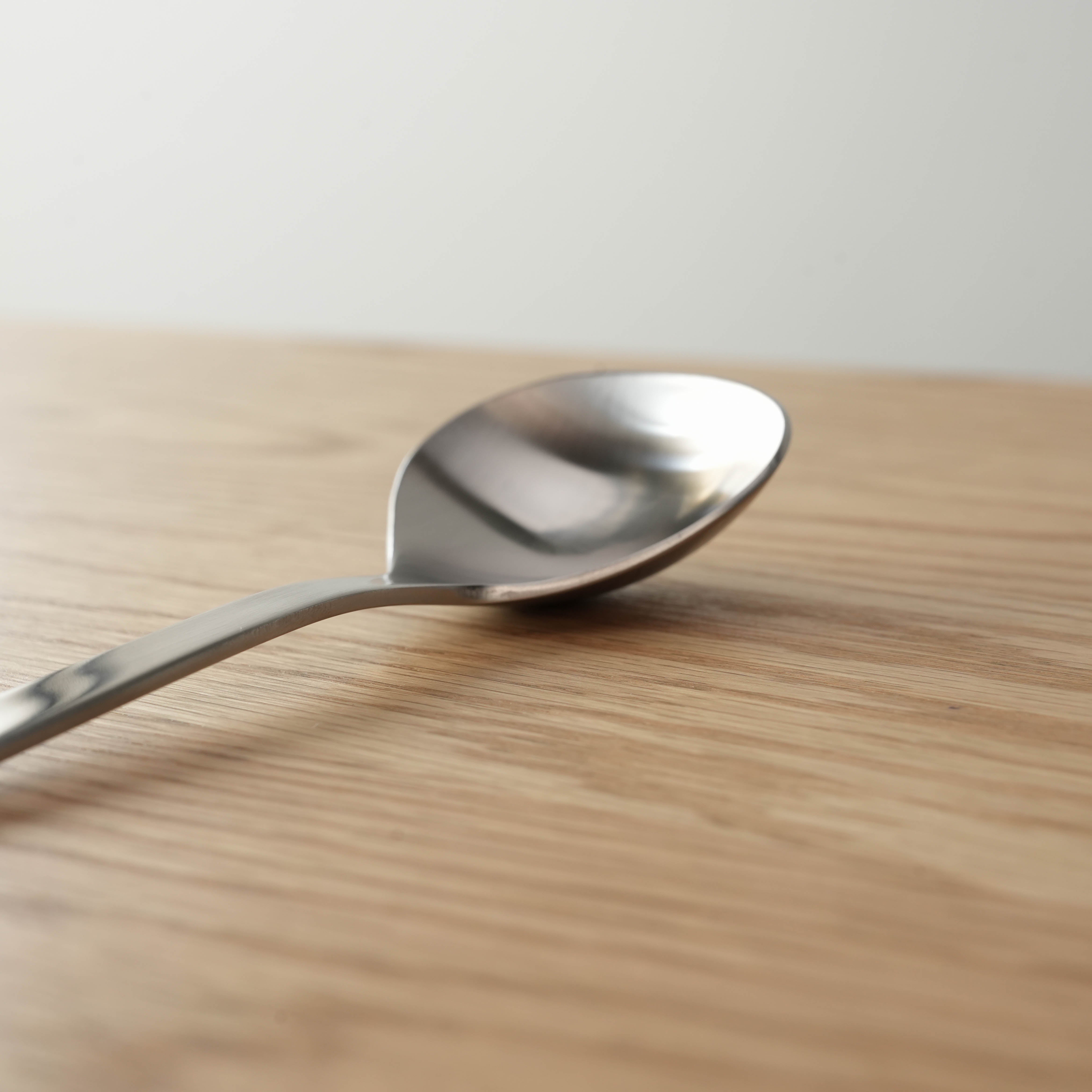Close-up of Sori Yanagi Stainless Steel Soup Spoon showing deep bowl and sleek finish. Perfect balance and design for kitchen use.