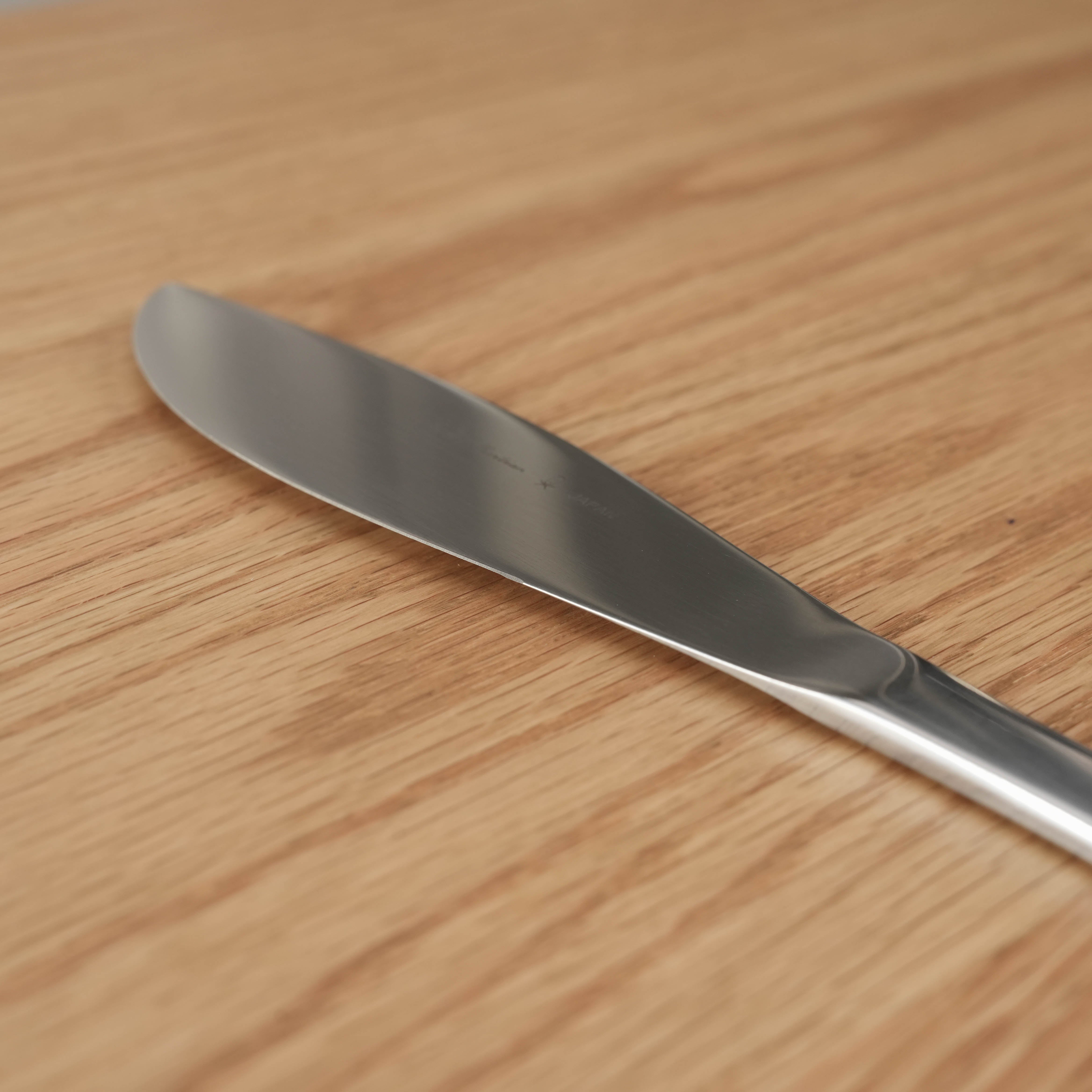 Sori Yanagi Table Knife - Stainless Steel | Dishwasher Safe, shown on wooden surface with sleek, ergonomic design ideal for modern dining.