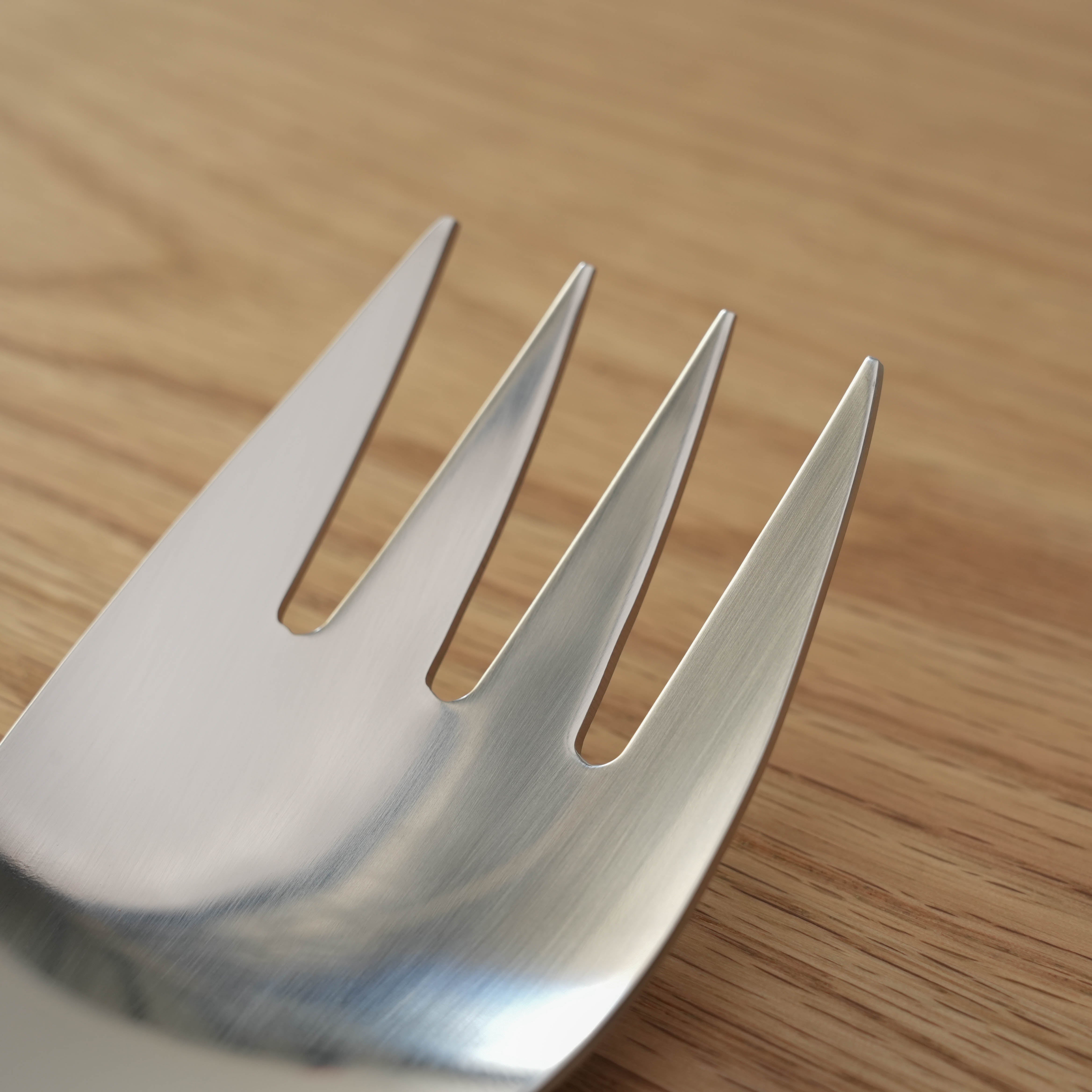 Close-up of Sori Yanagi Stainless Steel Serving Fork tines, showcasing precision Japanese craftsmanship and brushed metal texture.