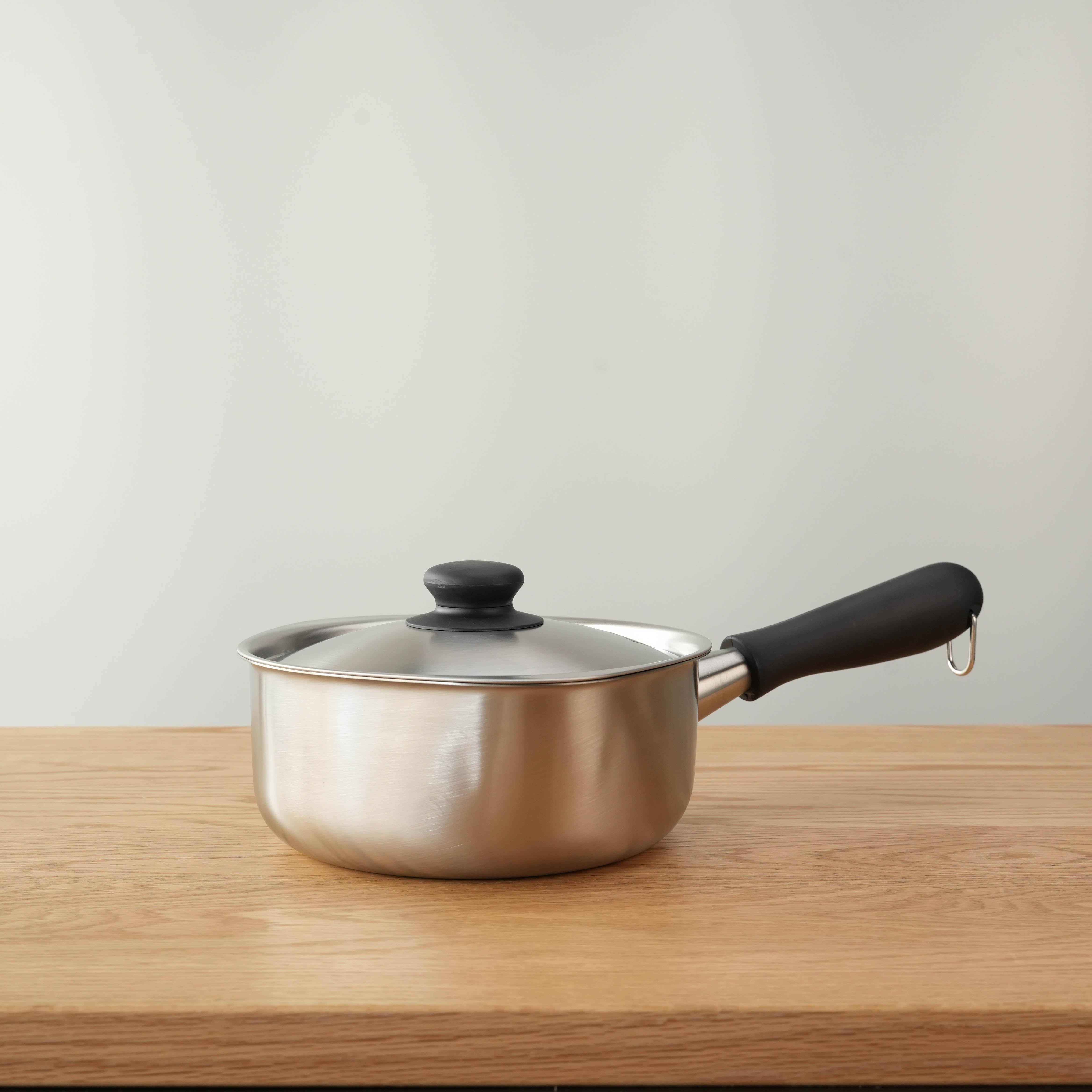 Side profile of Sori Yanagi Stainless Steel Saucepan with lid, highlighting its sleek Japanese design and induction-ready base.