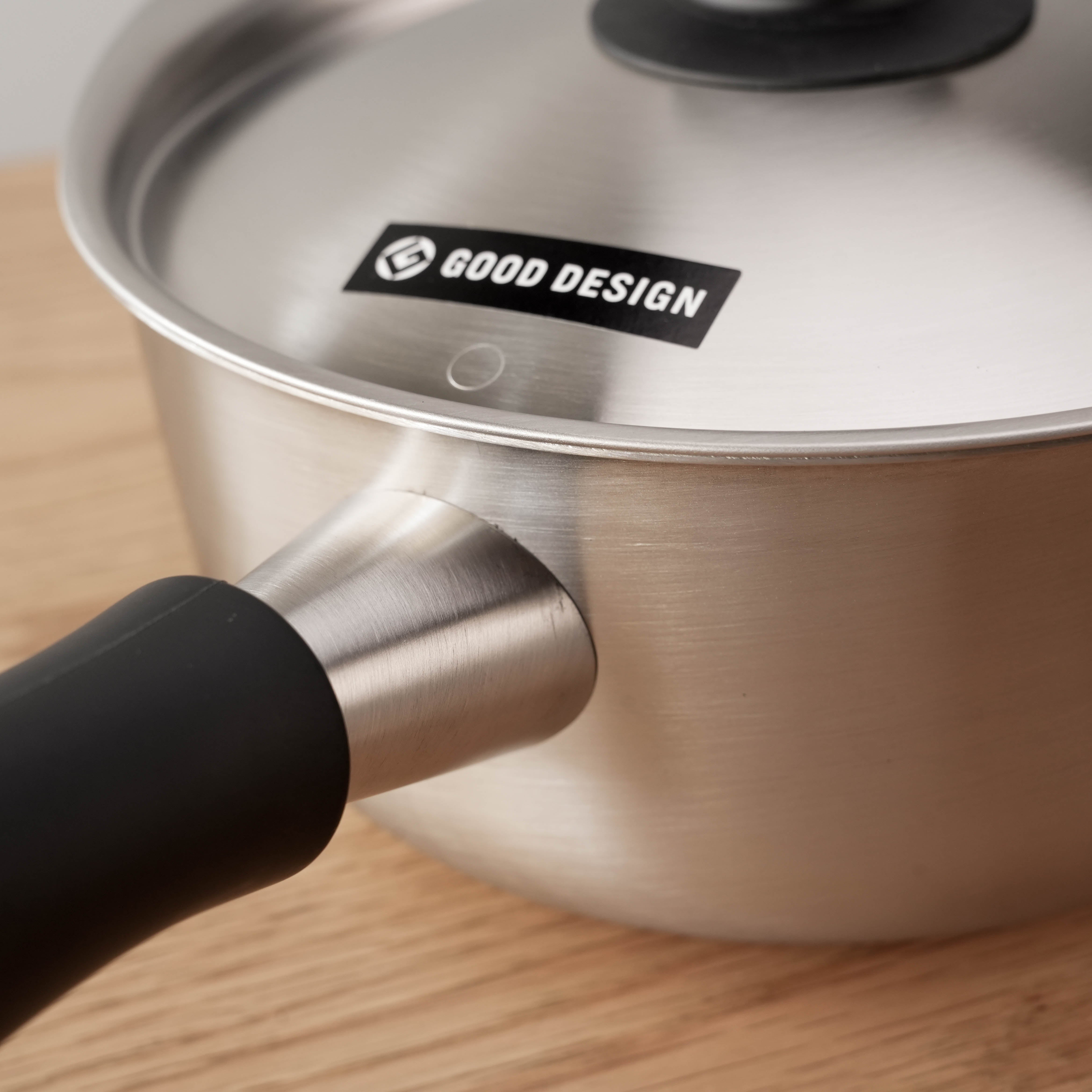 Detail of Sori Yanagi Stainless Steel Saucepan showing handle joint and Good Design logo, emphasizing quality and innovation.