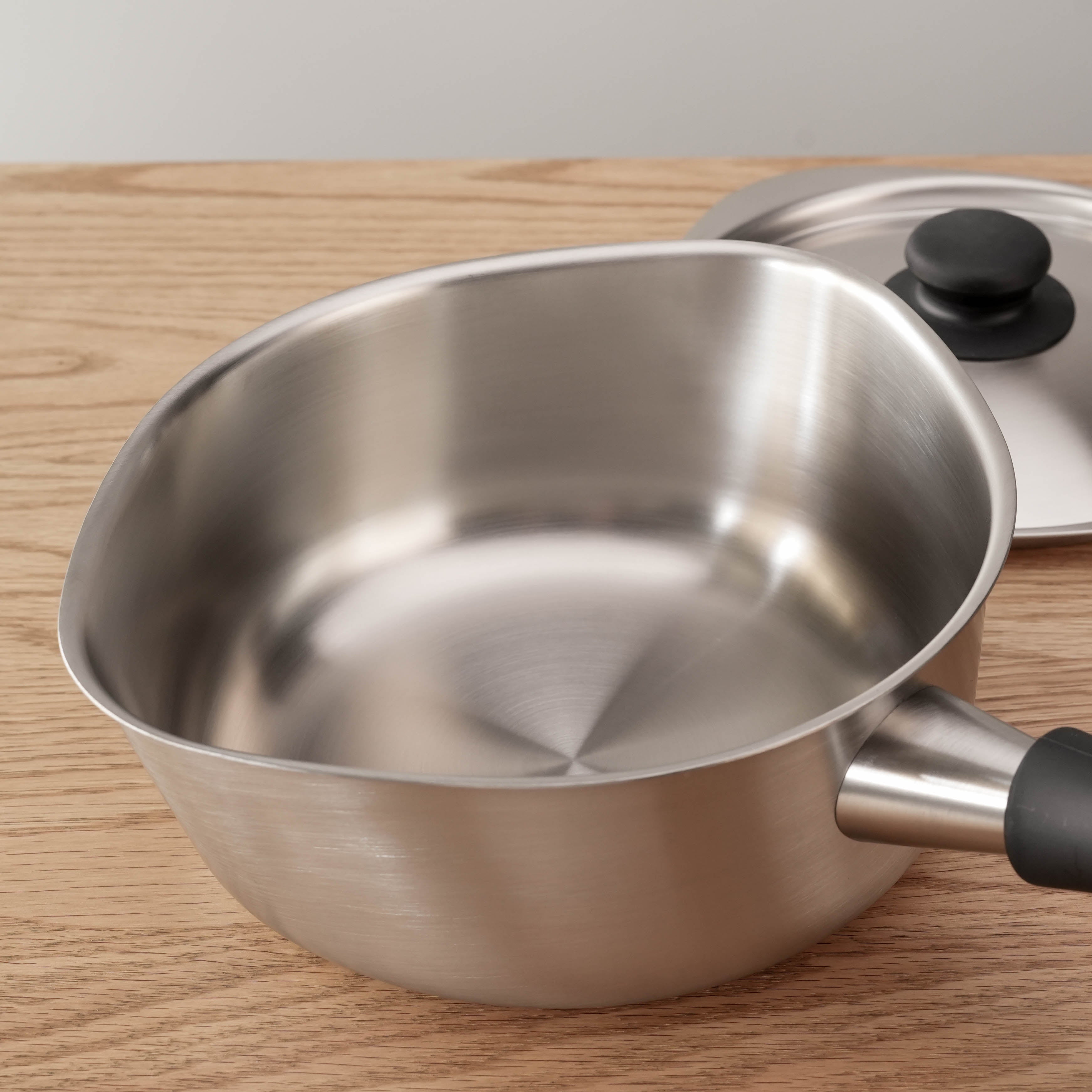 Interior view of Sori Yanagi Stainless Steel Saucepan showing seamless brushed steel finish and rounded corners for easy pouring.