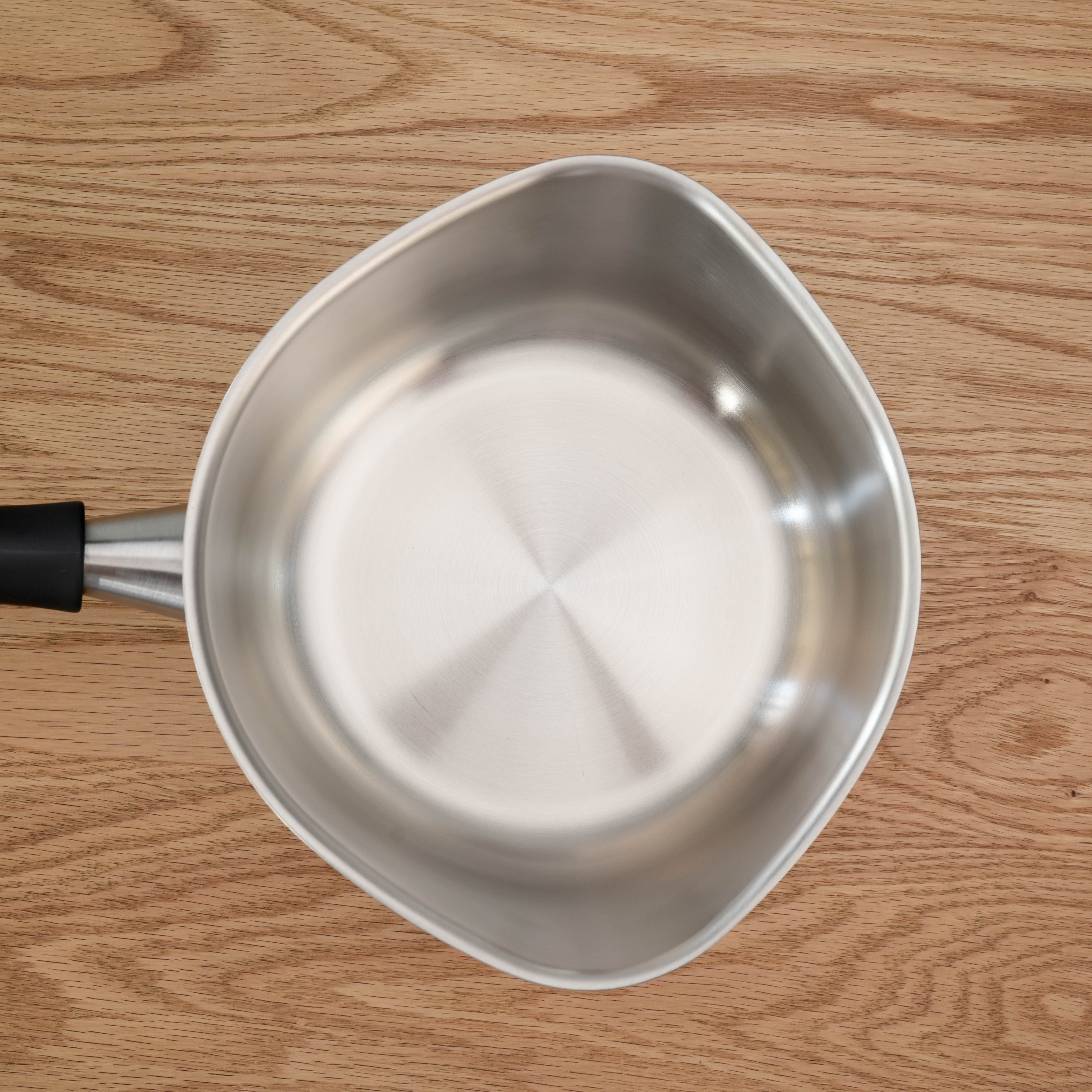 Overhead shot of Sori Yanagi Stainless Steel Saucepan interior, showcasing its wide, curved base for even heat distribution.