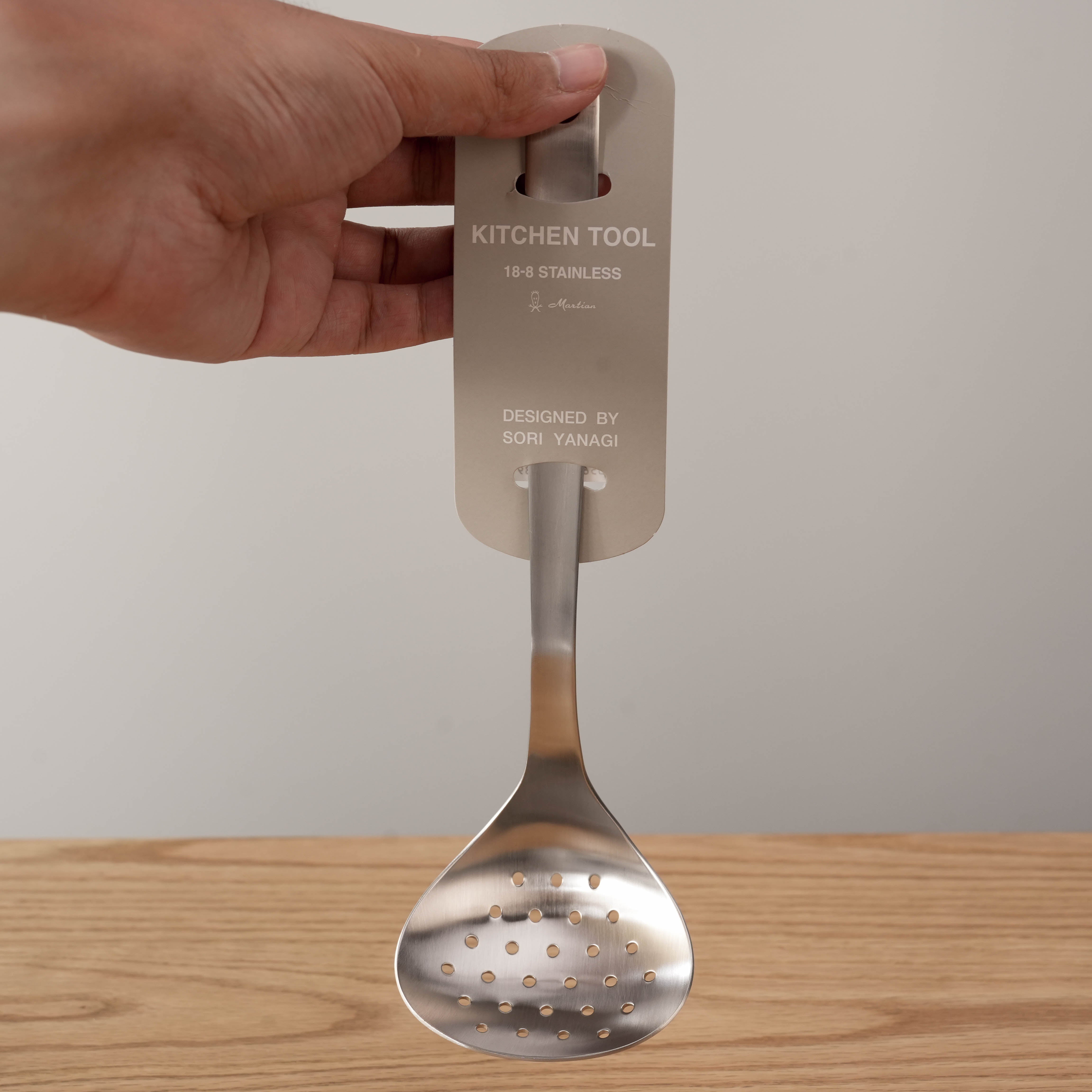Sori Yanagi Skimmer - Stainless Steel Strainer held upright, showcasing its sleek Japanese craftsmanship and balanced stainless steel construction.