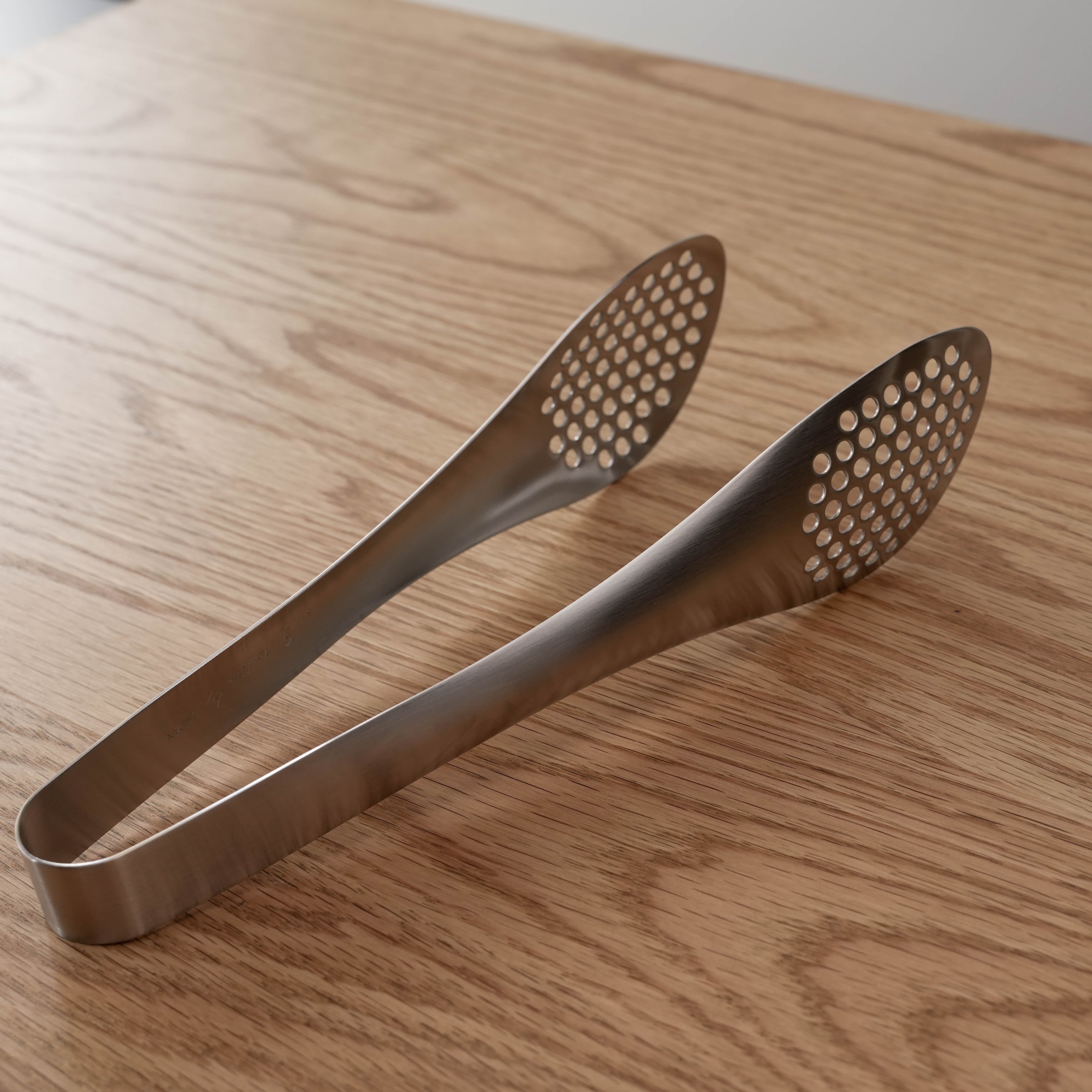 Sori Yanagi Steel Tongs with perforated tongs, showcasing their seamless stainless steel design for kitchen use.