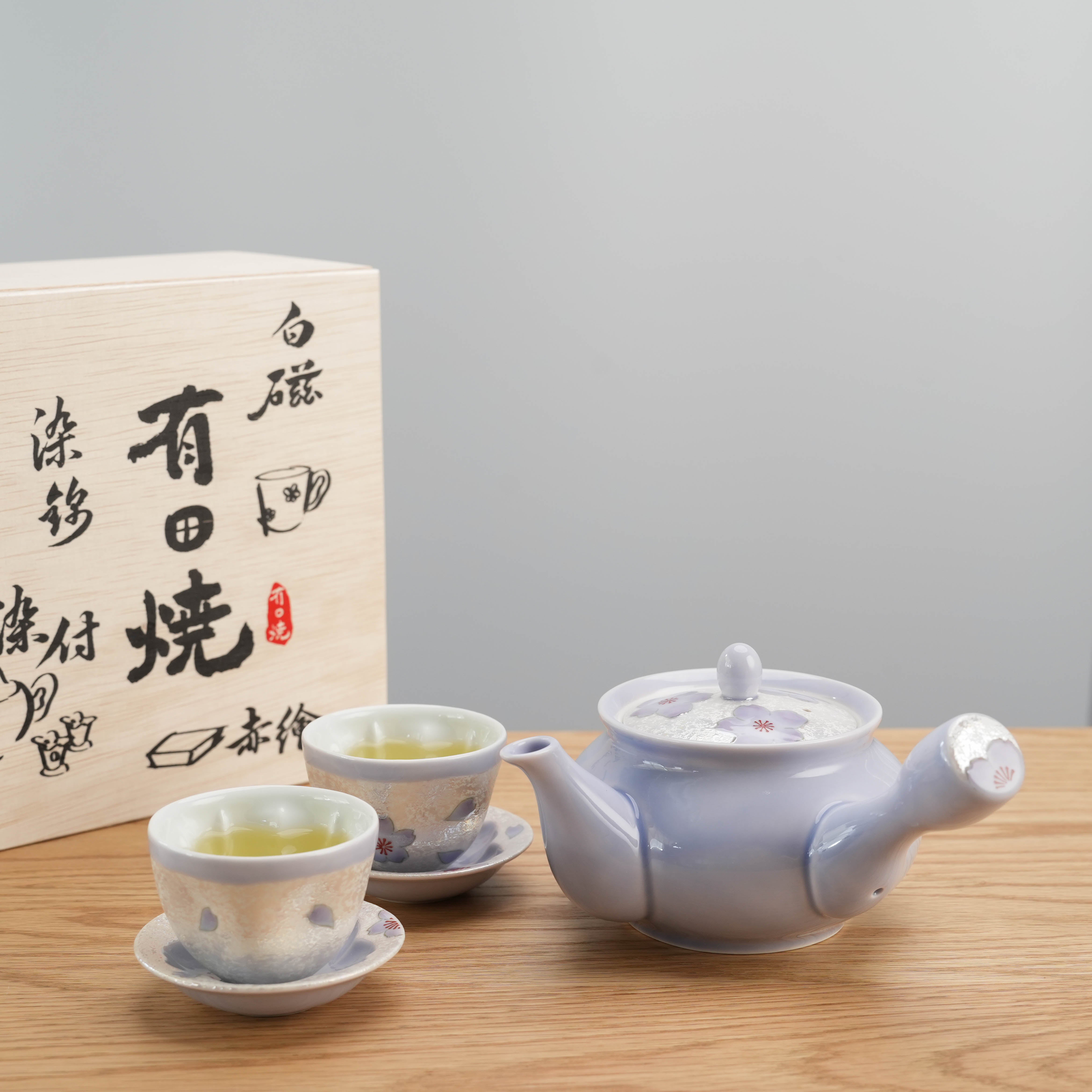 Arita Ware Lilac Blossom Tea Set displayed with wooden box packaging, featuring Japanese calligraphy and elegant seasonal tea design.