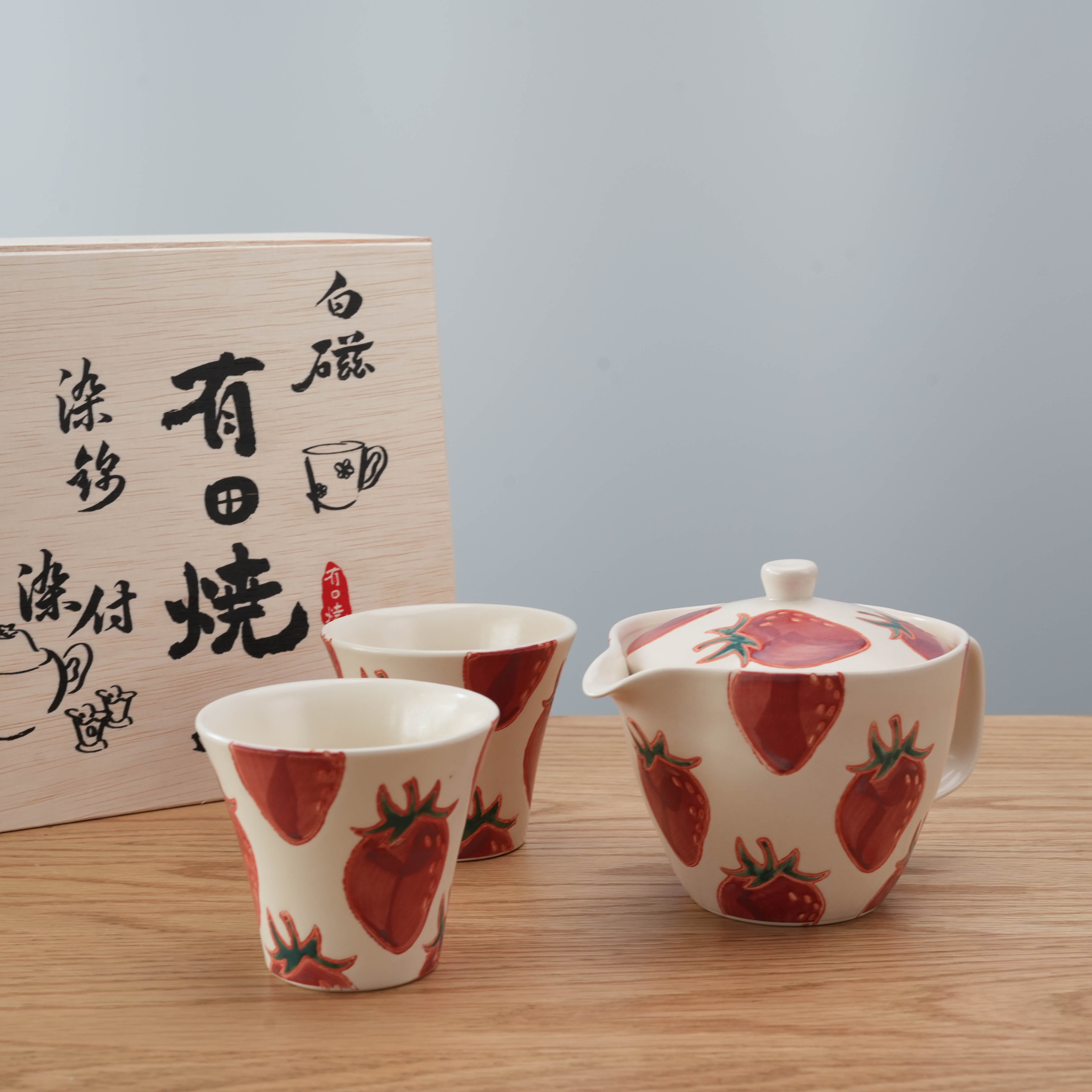 Japanese Hasami Ware Strawberry Tea Set with teapot and cups displayed beside traditional wooden box, perfect for gifting or home decor.