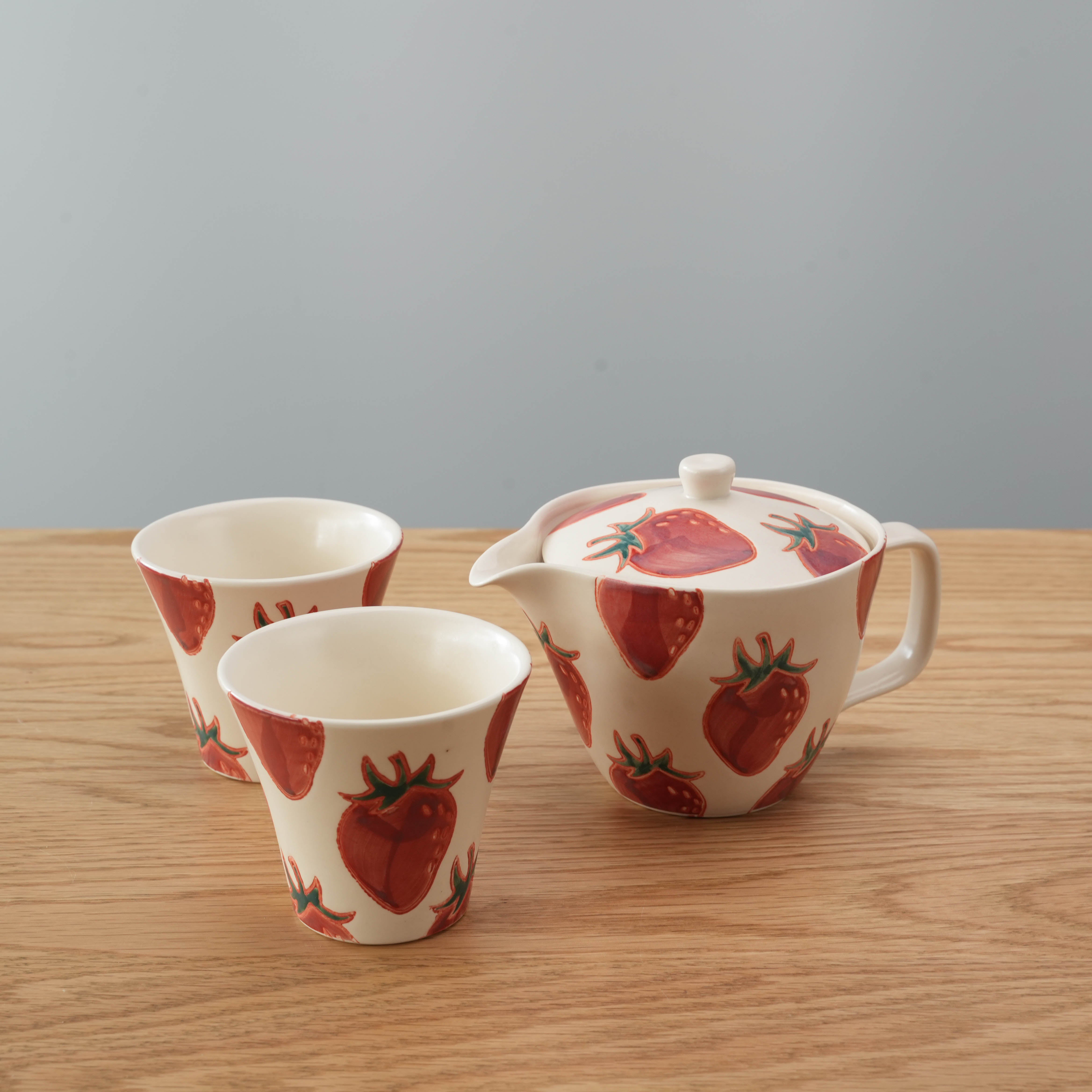 Hasami Ware Strawberry Tea Set with 300ml teapot and two matching cups featuring hand-painted red strawberries, ideal for Japanese-style tea time.