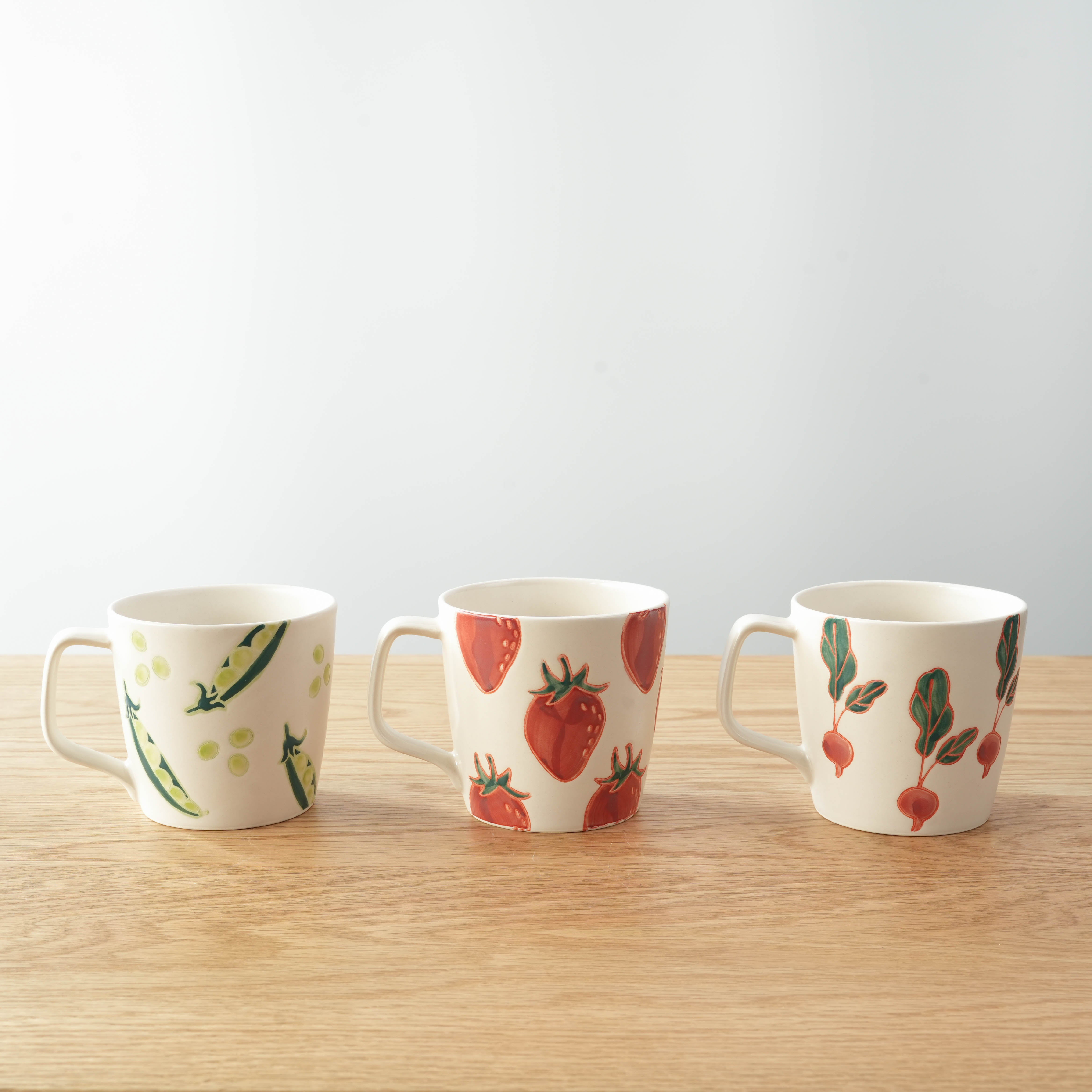 Set of three Hasami Ware Mugs with strawberry, beet, and pea motifs. Unique Japanese drinkware for home dining or thoughtful gifts.