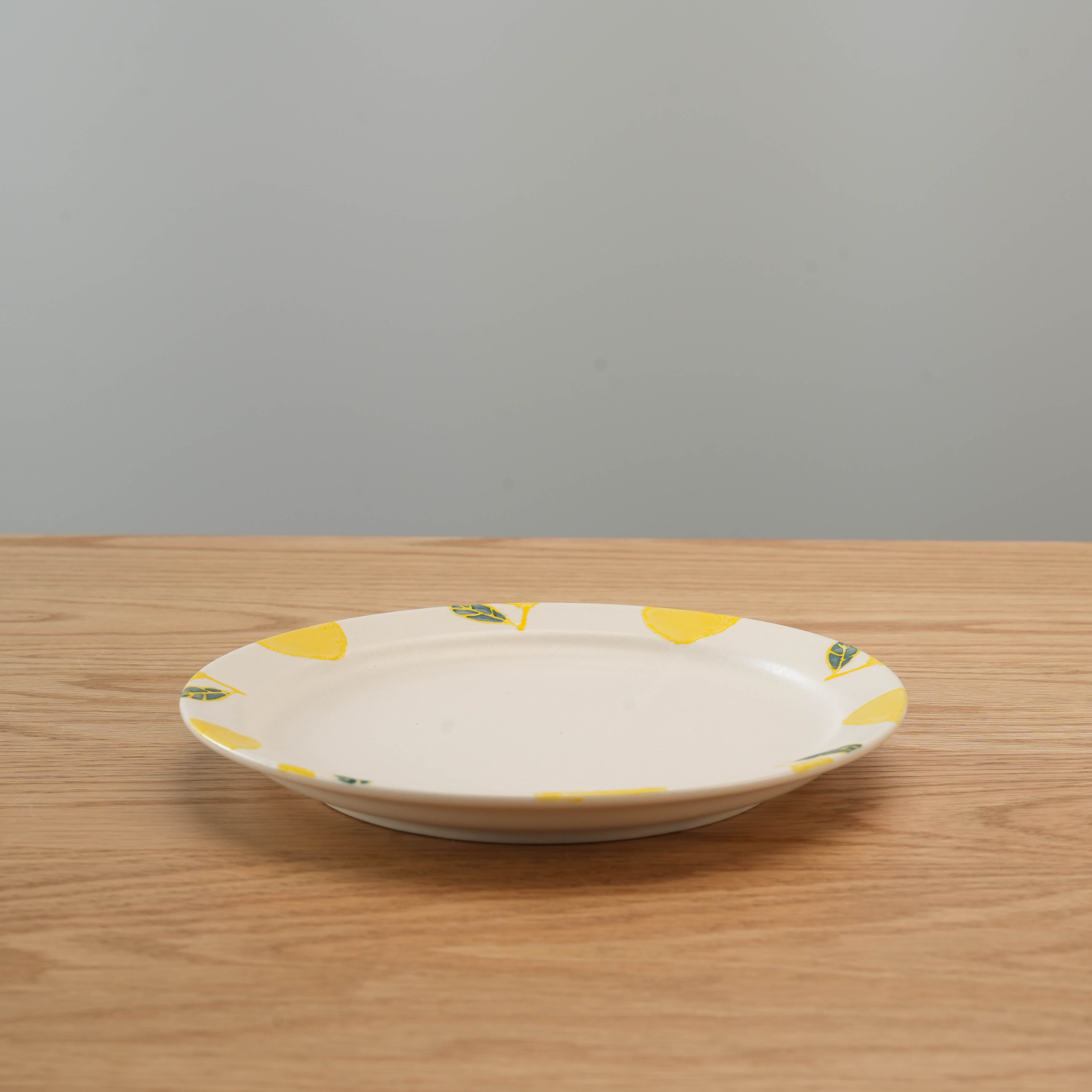 Medium round Hasami Ware Lemon Plate with hand-painted lemon motifs, perfect for everyday dining or gifting in Japanese kitchenware collections.