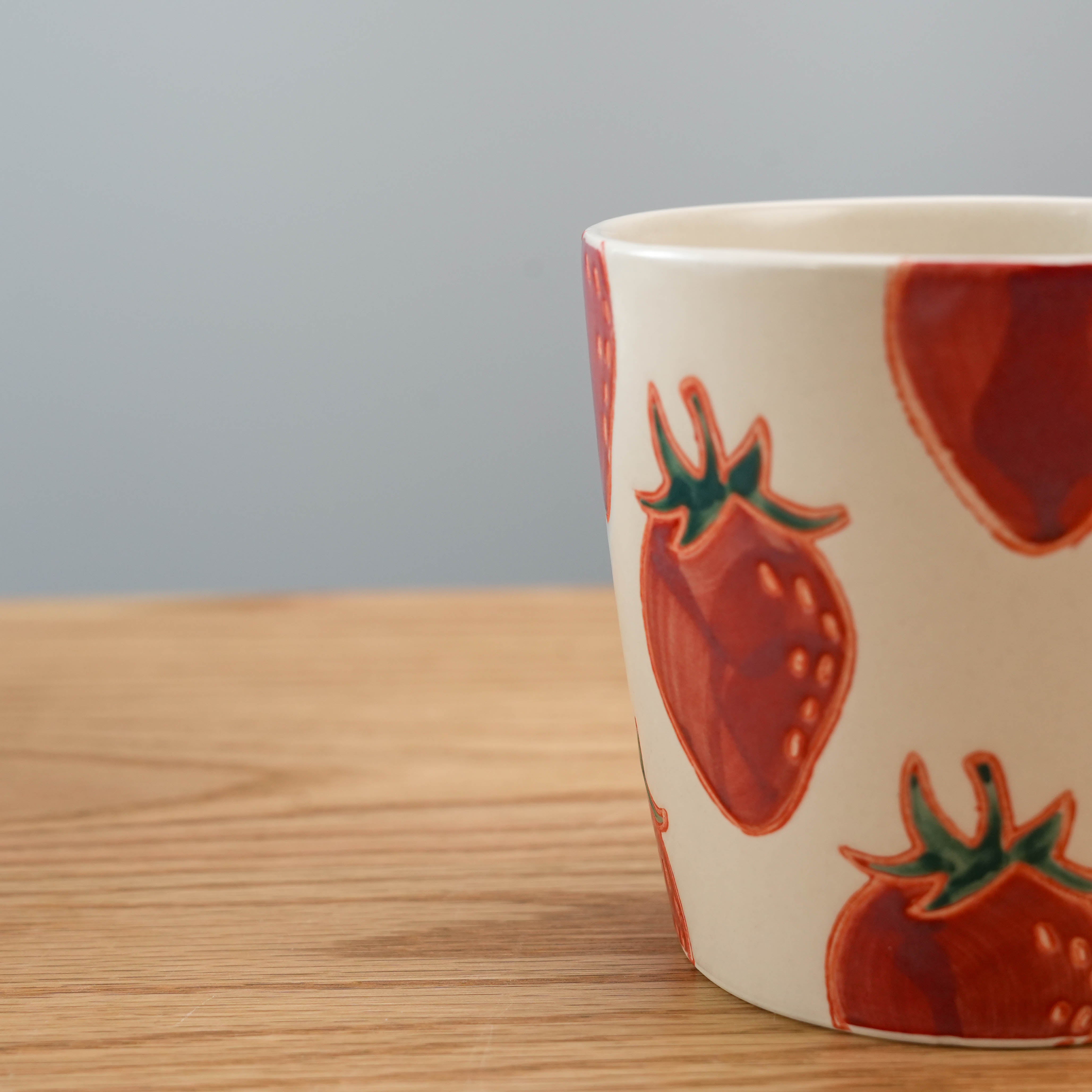 Close-up of Hasami Ware Strawberry Mug showing detailed red fruit artwork. Ideal for adding charm to your drinkware collection.