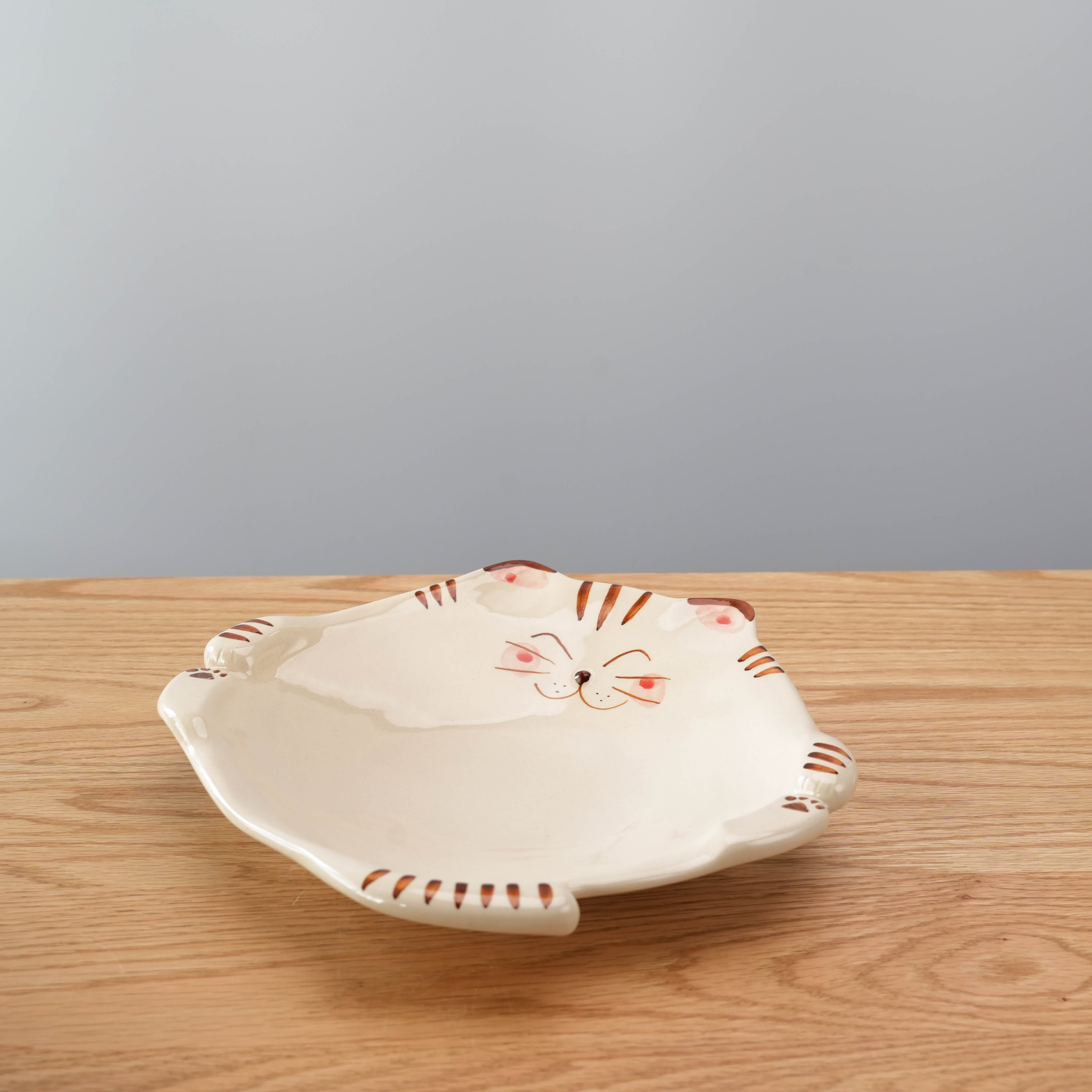 Lucky Cat Plate - Tiger by Hasami Ware featuring a handcrafted tiger cat face with ear-shaped edges, ideal for Japanese-style tableware collections.
