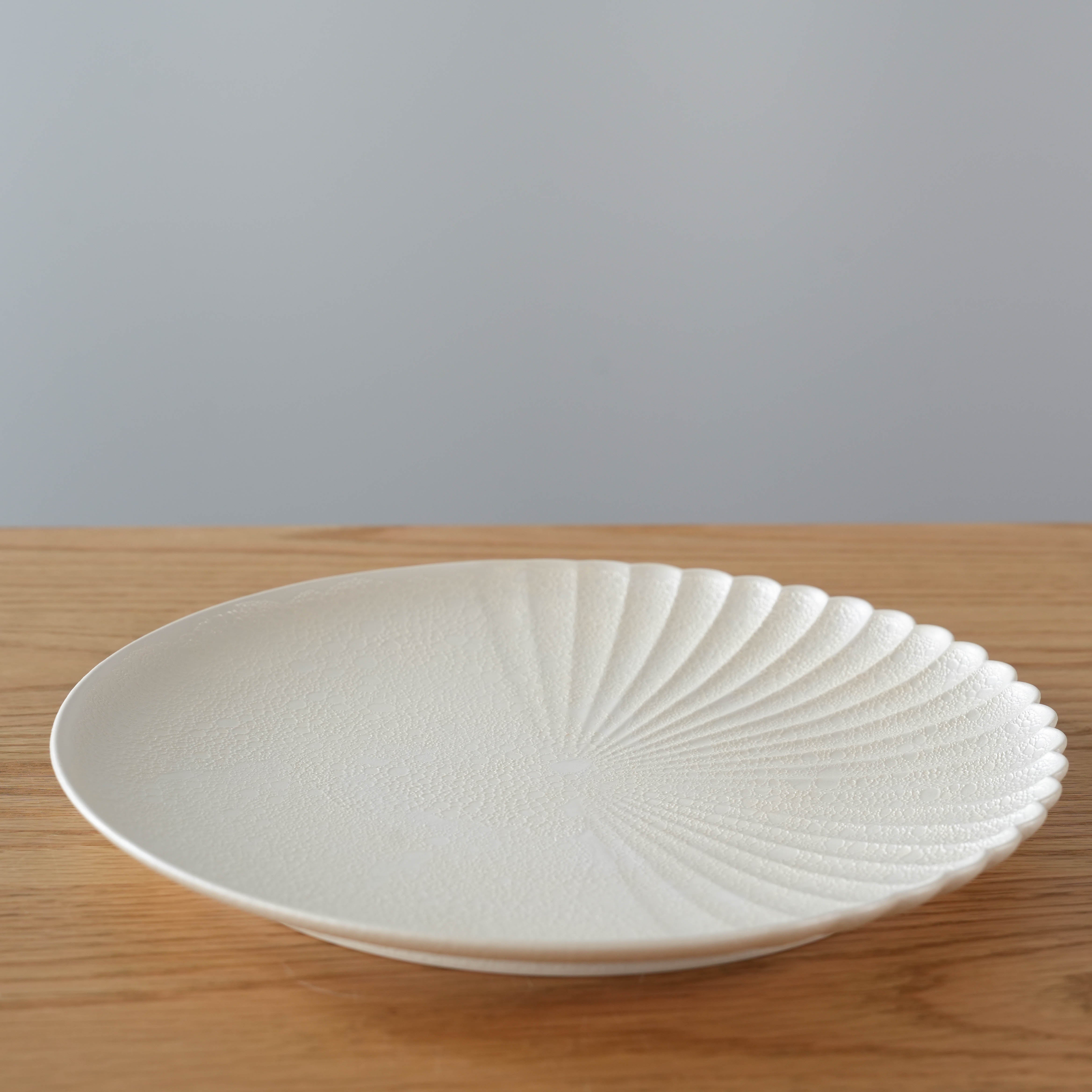 Japanese Arita Ware plate featuring one-sided chrysanthemum carving and pearl-toned bubble design, perfect for refined dining settings.