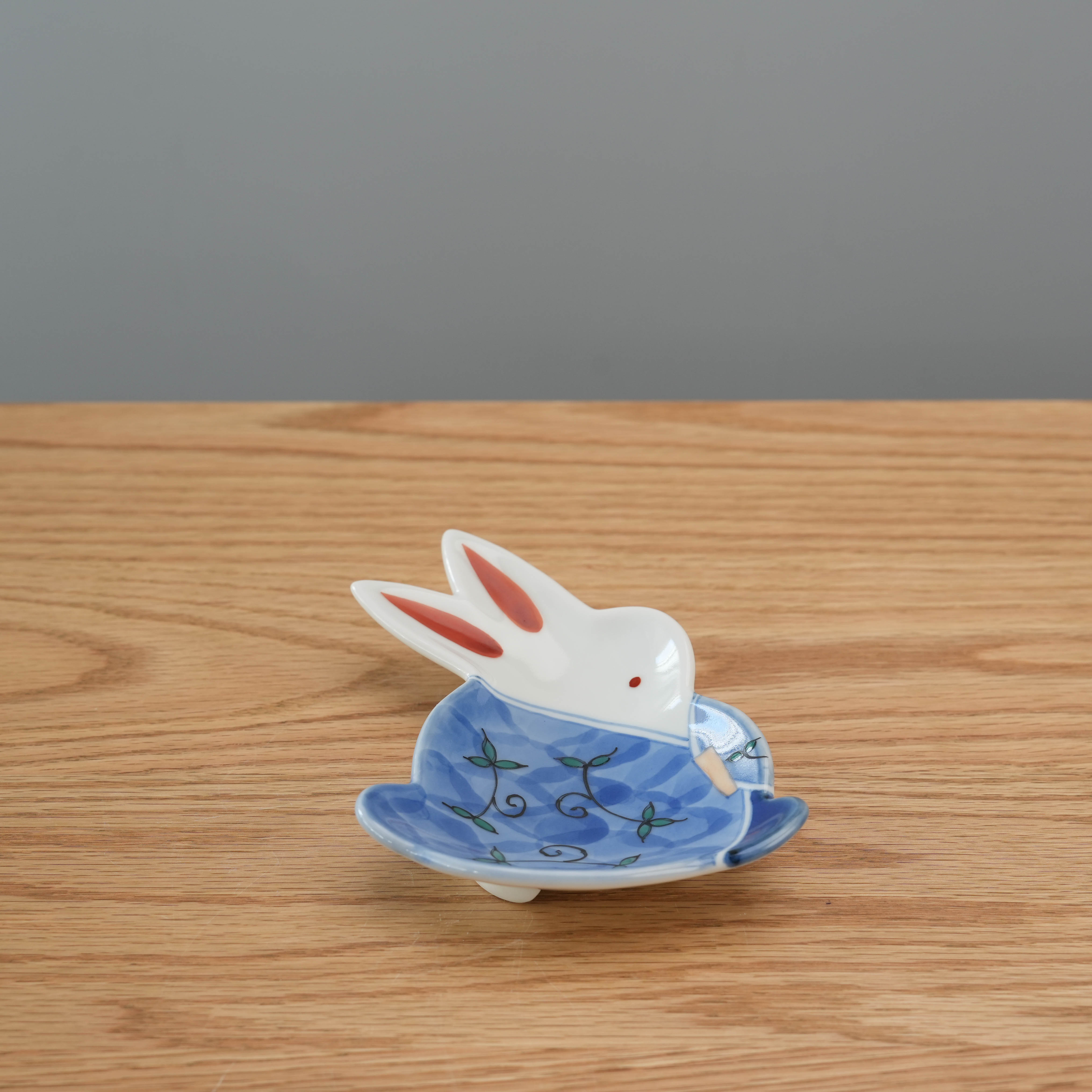Arita Ware rabbit shaped small plate in blue with floral design, ideal for side dishes or fruit. Made in Japan for elegant table settings.