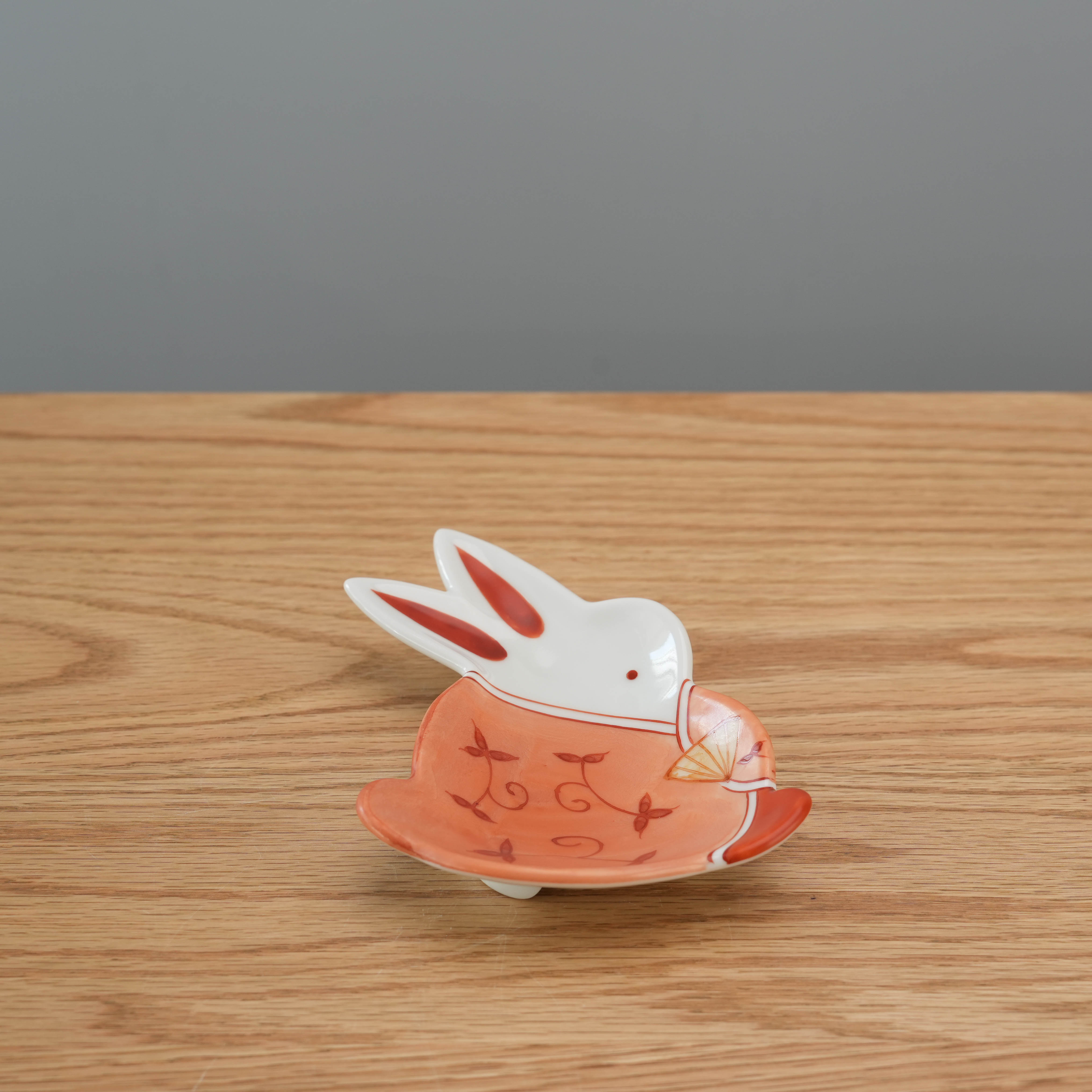 Arita Ware rabbit shaped small plate in orange with delicate fan and vine pattern. Japanese craftsmanship perfect for kitchen and dining decor.