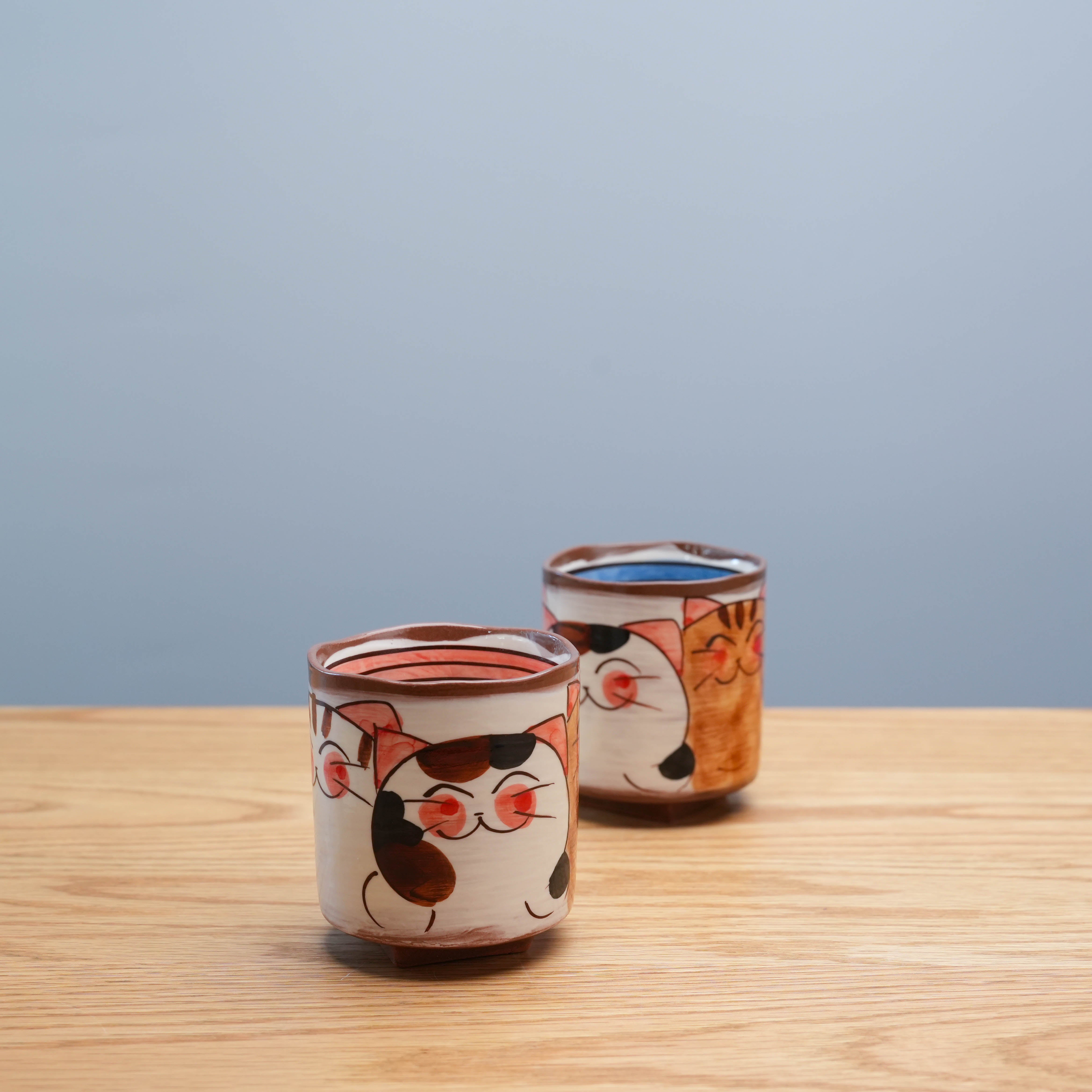 Set of Hasami Ware Three Friendly Cat Tea Cups with charming Japanese cat illustrations and square base, ideal for tea lovers and collectors.