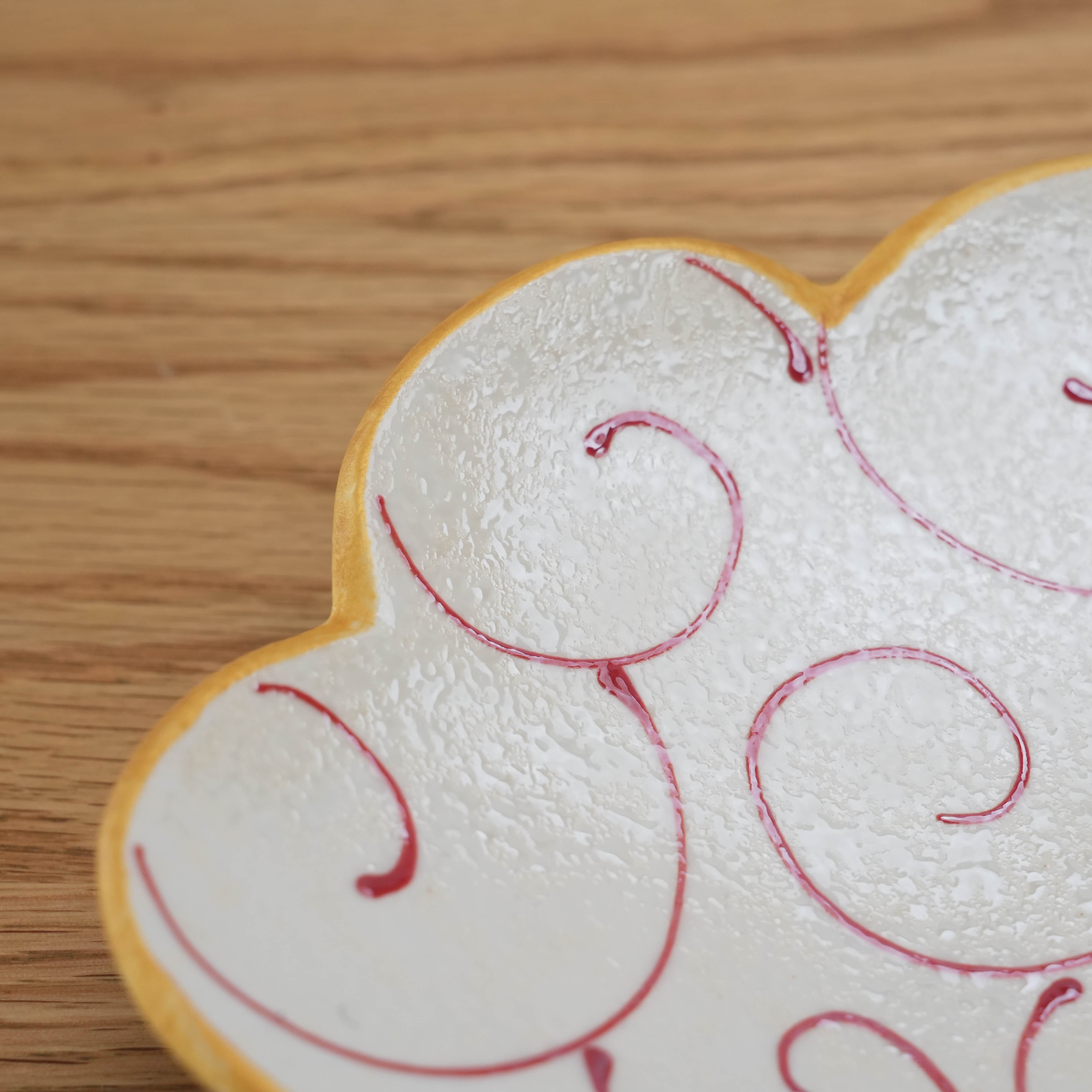 Detail view of red arabesque design on Hirado Ware Cloud Plate, highlighting the textured finish and cloud-inspired shape for serving.