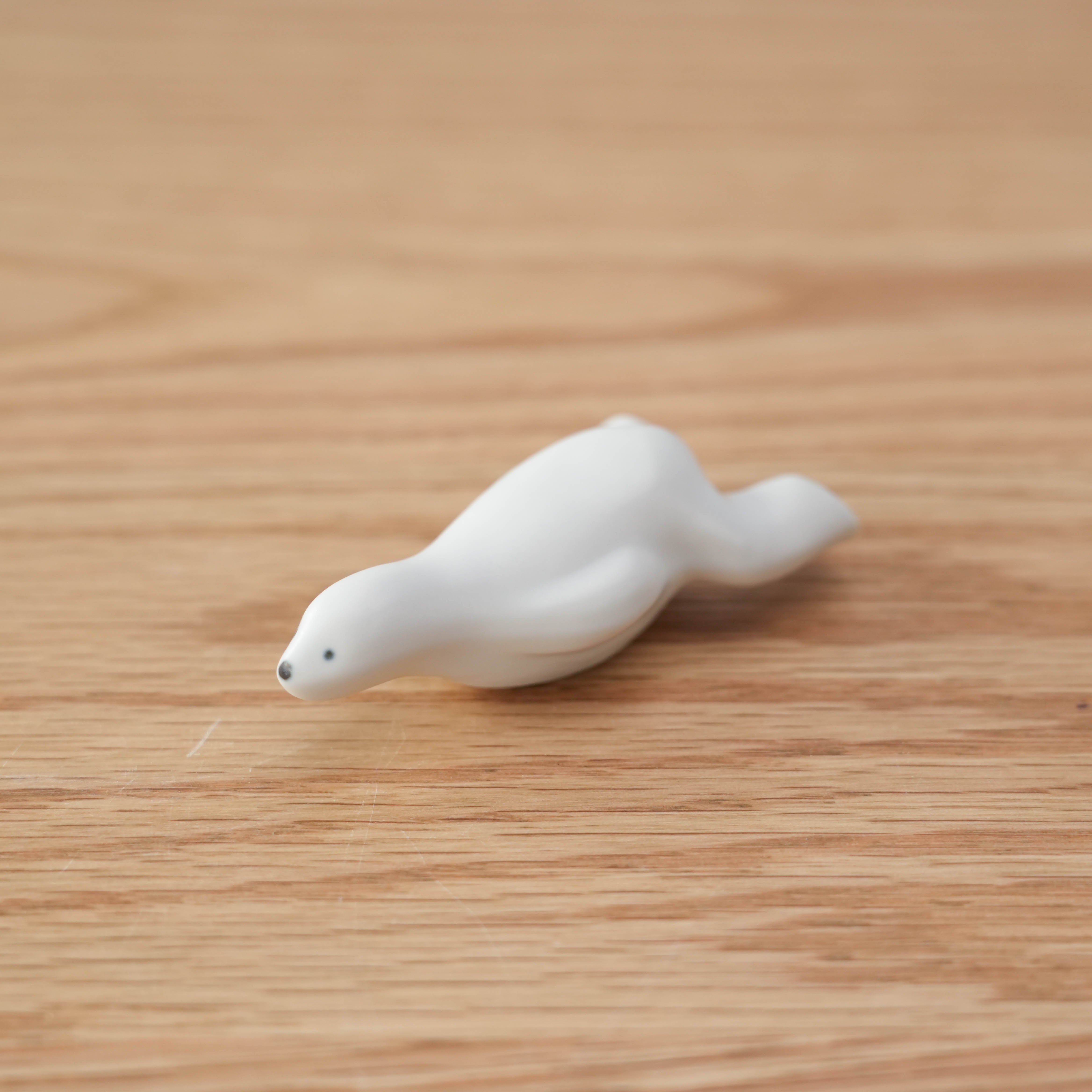 Arita Ware Polar Bear Chopstick Rest in a sleek white ceramic finish, shaped like a lounging bear, made in Japan for elegant table settings.