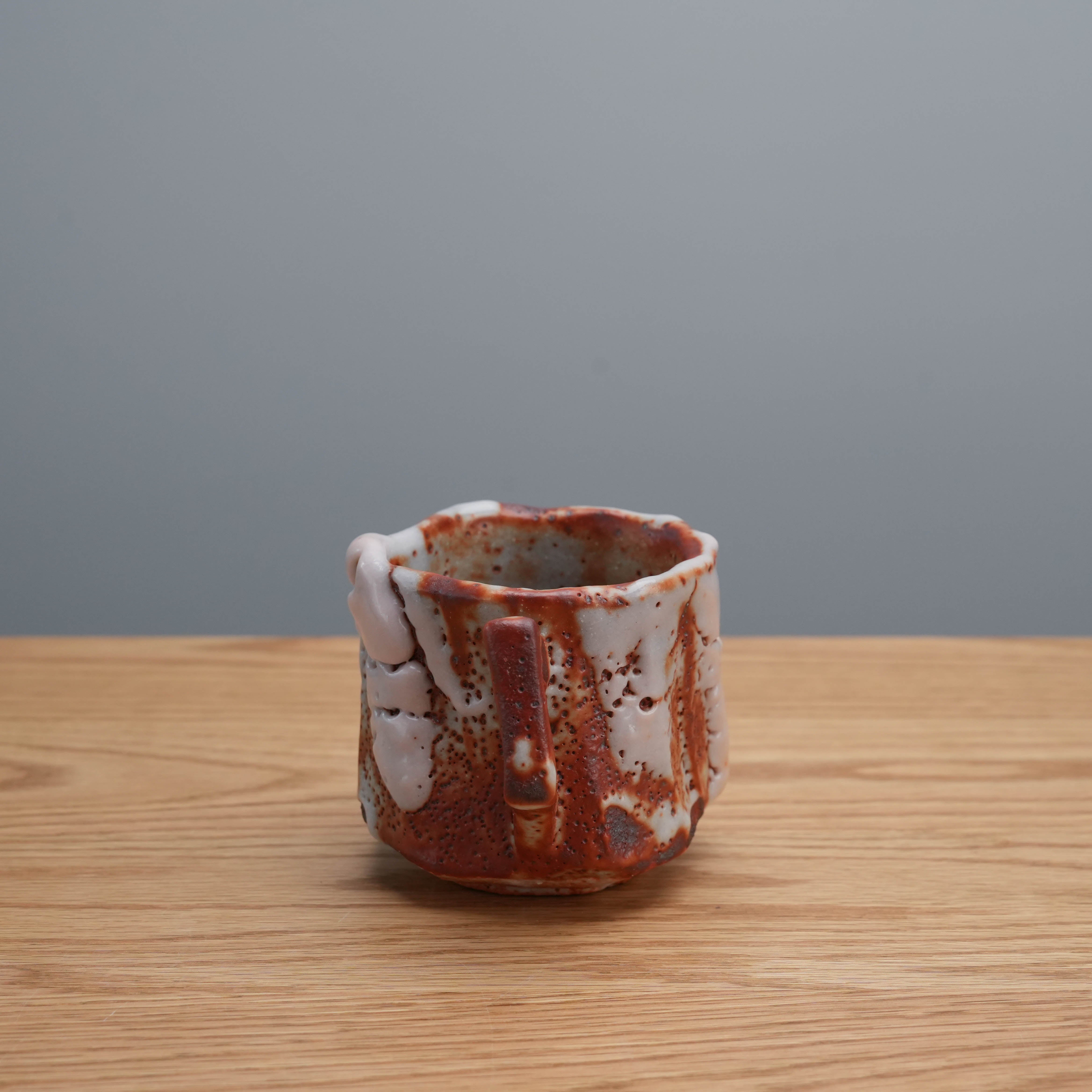 Rear view of Kano Shinji Mino Ware Cup highlighting the unique Shino glaze and sculpted handle in Japanese ceramic style.
