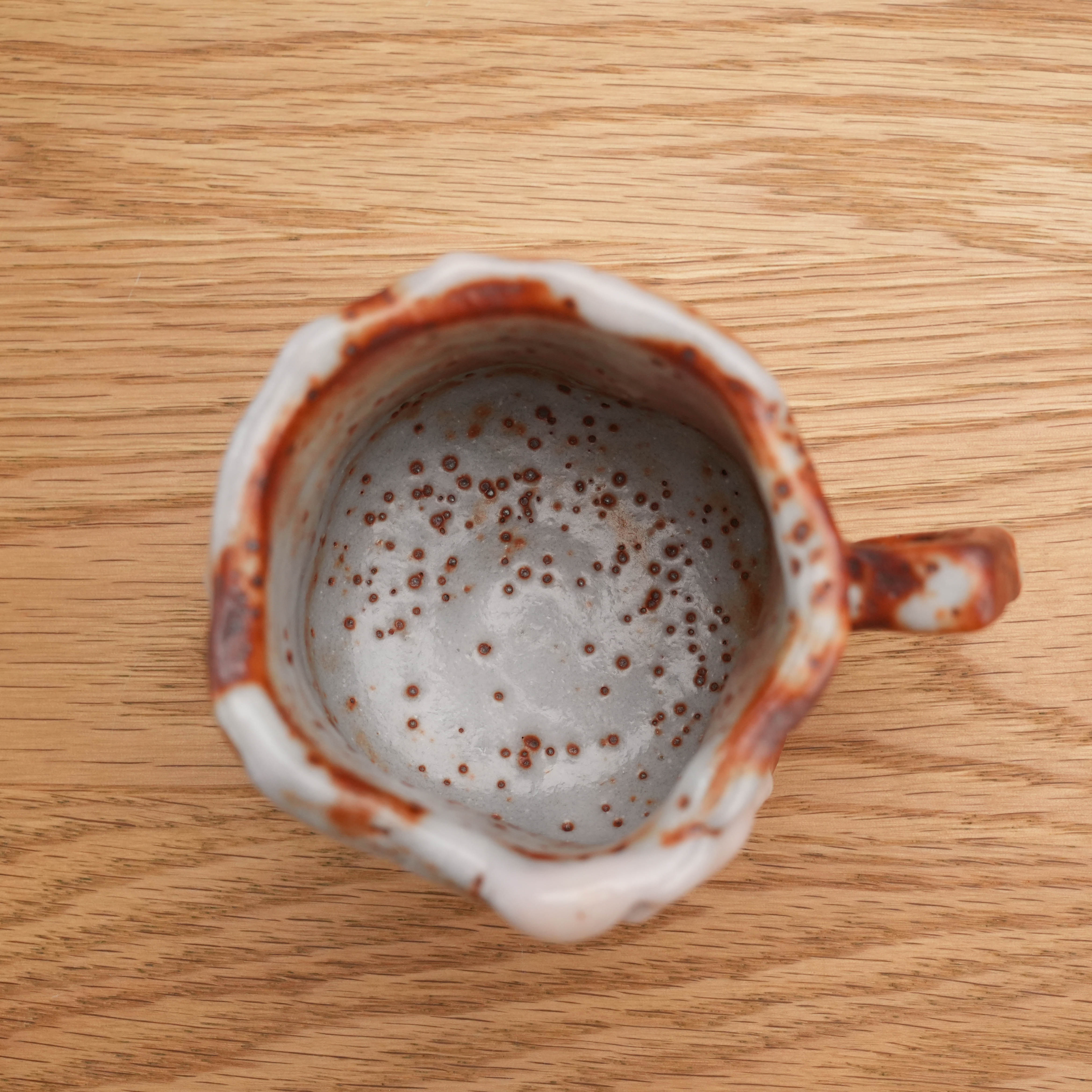 Top view of Mino Ware Shino ceramic cup by Kano Shinji, revealing speckled interior glaze and handcrafted texture.