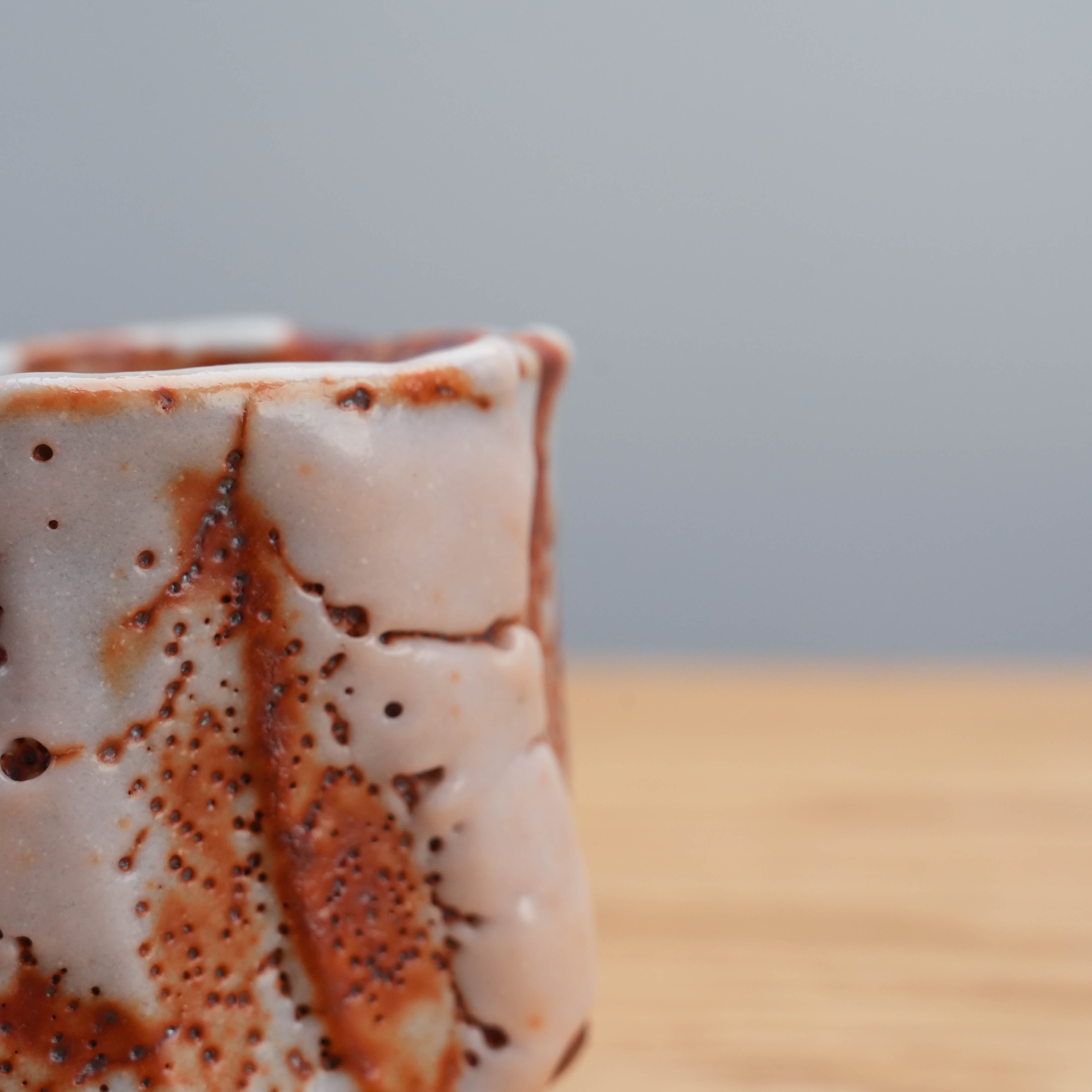 Close-up of textured surface and glaze pattern on Mino Ware Shino cup by Kano Shinji, highlighting handcrafted detail.