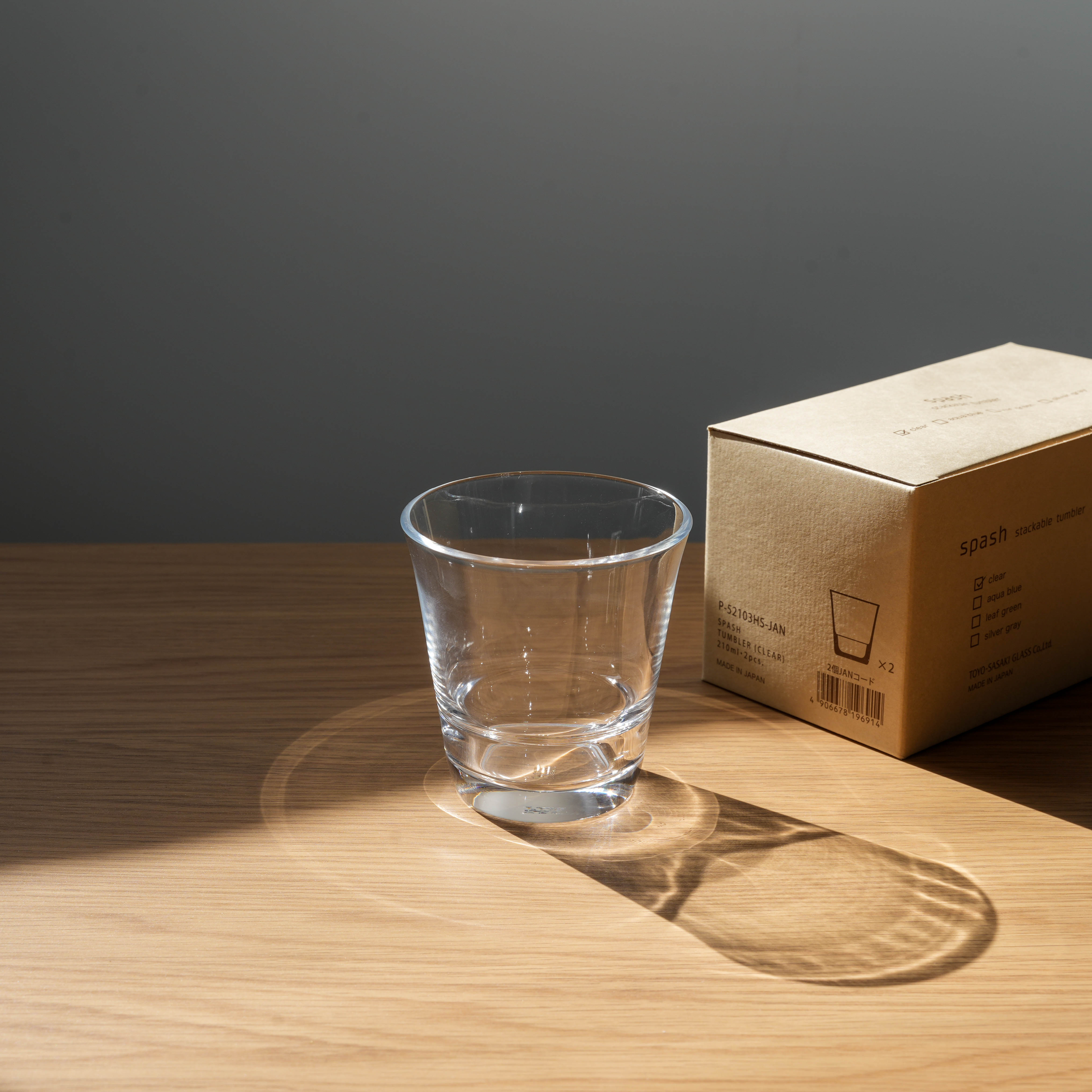 Clear Toyo-Sasaki Splash tumbler beside its box, highlighting durable, stackable Japanese drinkware for home and garden dining.