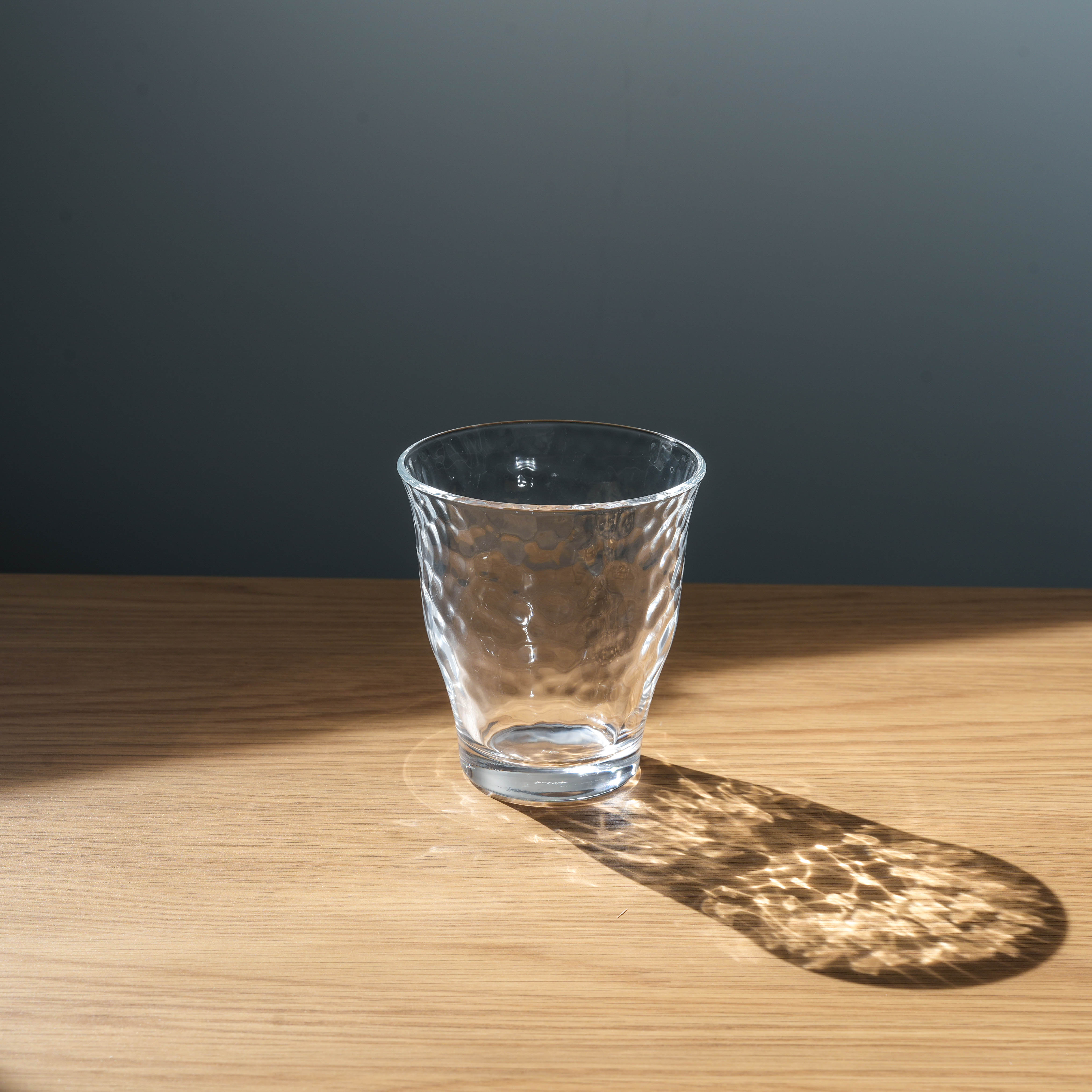 Elegant Irodori Seikatsu Glass Cup by Toyo-Sasaki, featuring a hammered interior and clear finish, ideal for refined table settings and daily use.