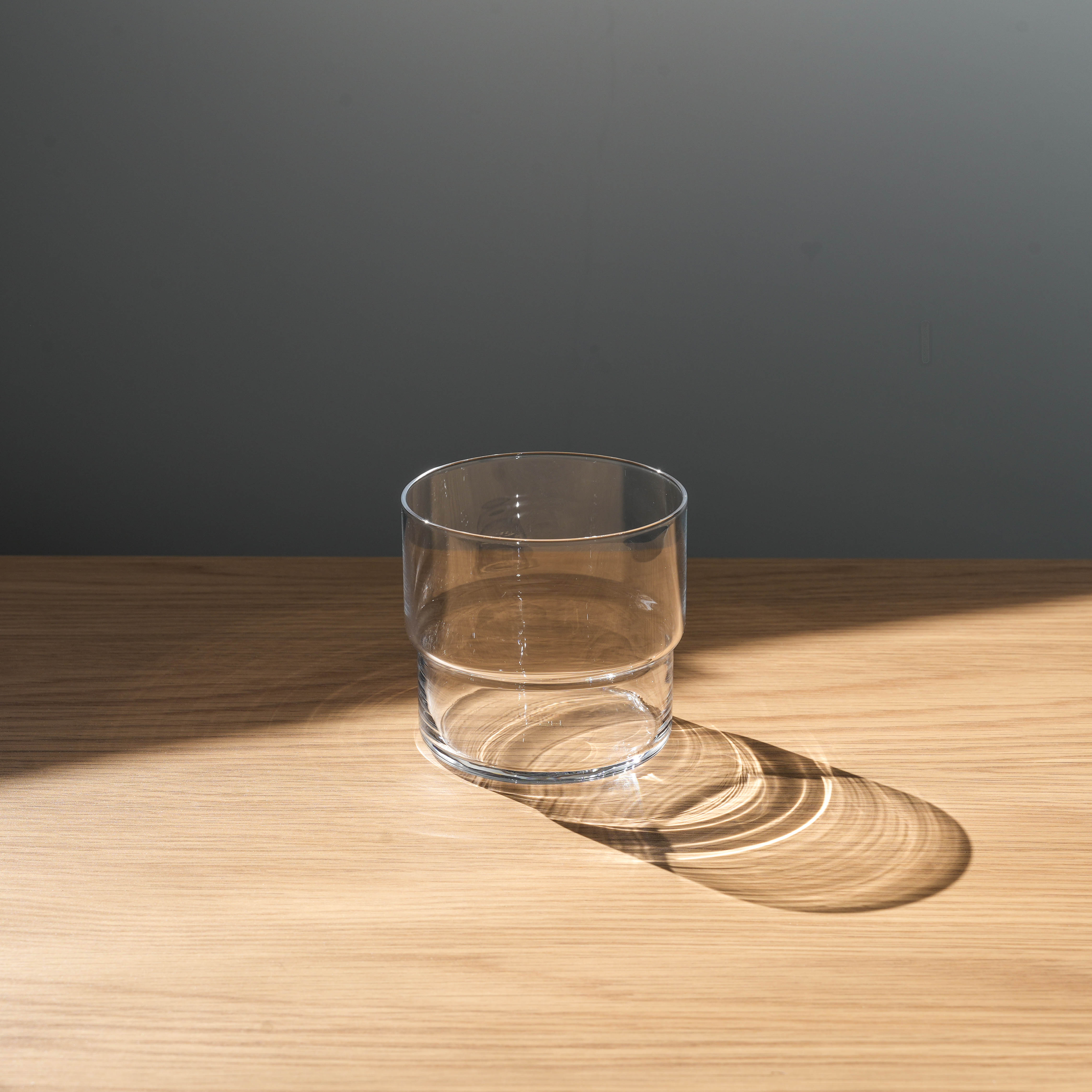 Toyo-Sasaki HS Fino Tumbler - Japan Glassware sits on wooden surface, showcasing its stackable, minimalist design for home or commercial drinkware use.