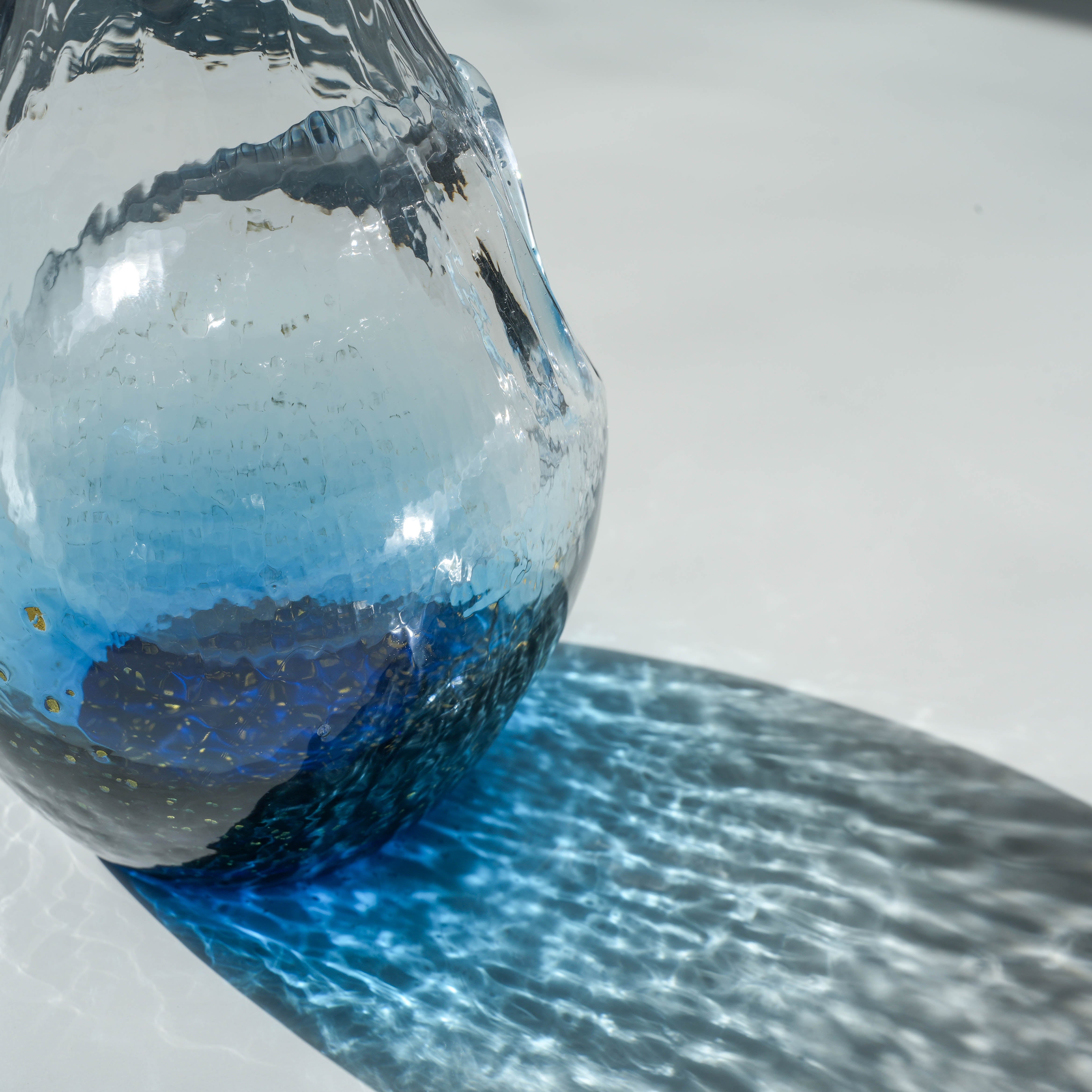 Detailed view of the Toyo-Sasaki Sapphire Blue sake carafe, highlighting the textured Edo Glass and gradient blue design.