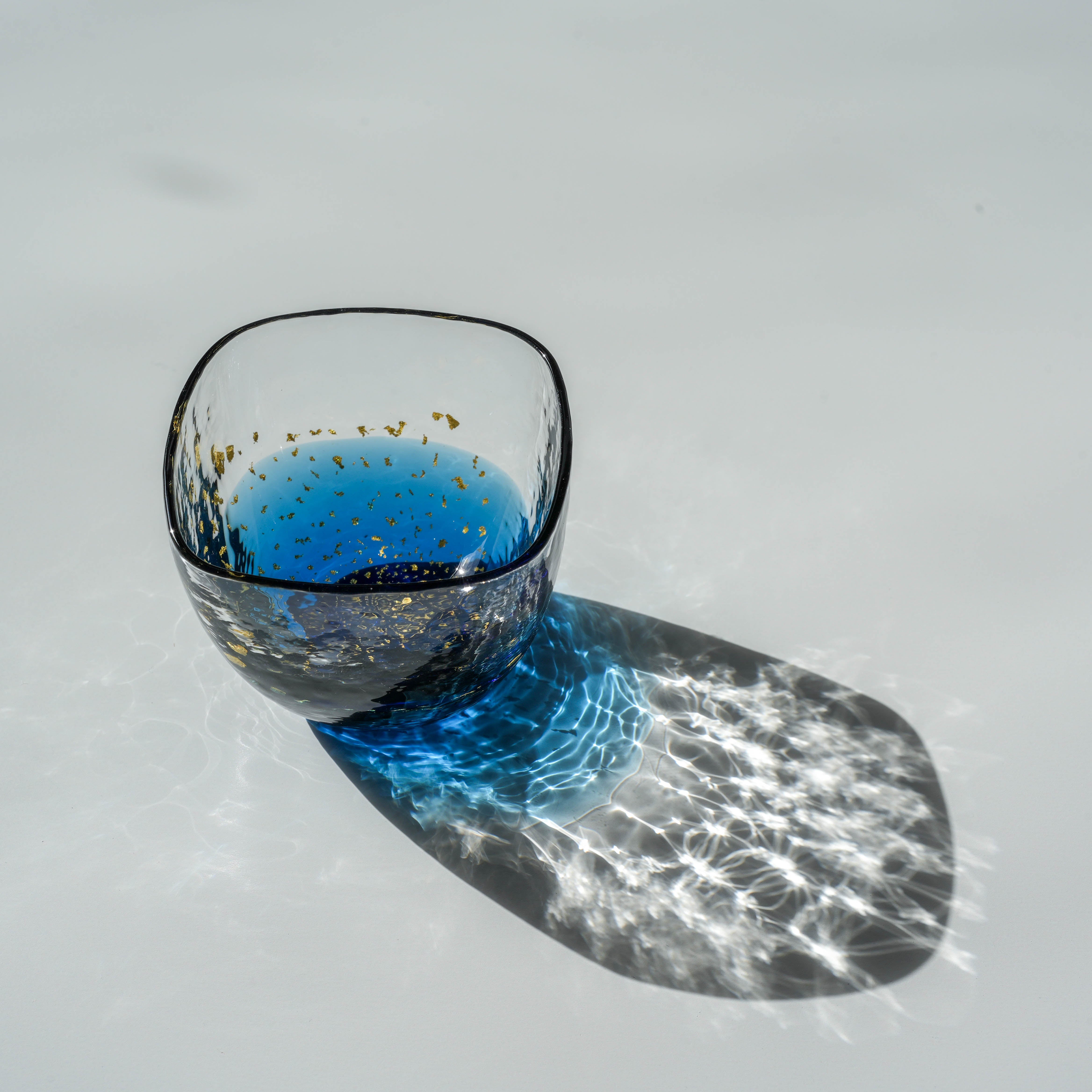 Handcrafted Toyo-Sasaki Sapphire Blue sake cup with shimmering gold details, ideal for elegant home dining or gift occasions.