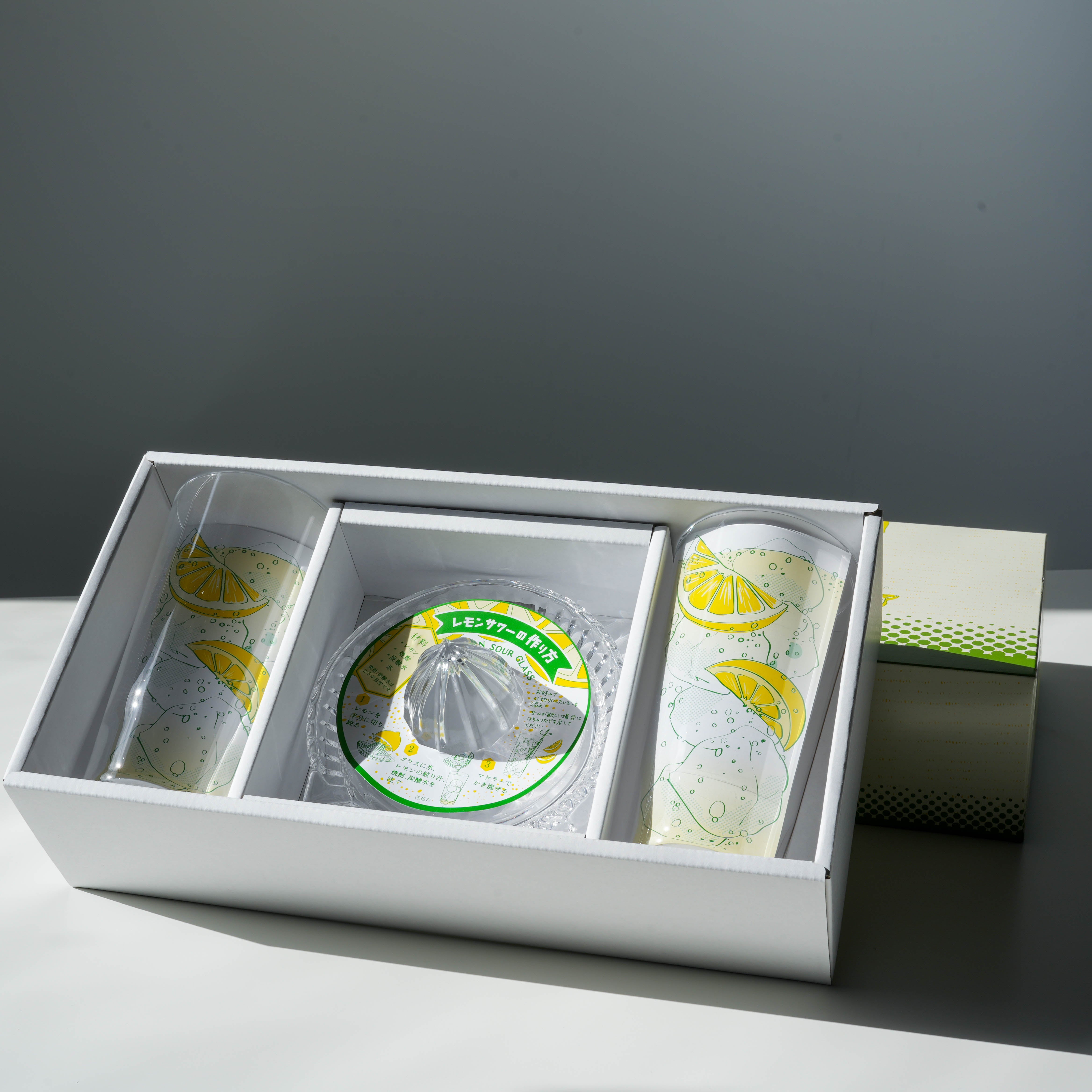 Boxed Toyo-Sasaki Lemonade Glass Set with two printed glasses and a citrus squeezer, ideal for stylish drinkware in kitchen and dining use.