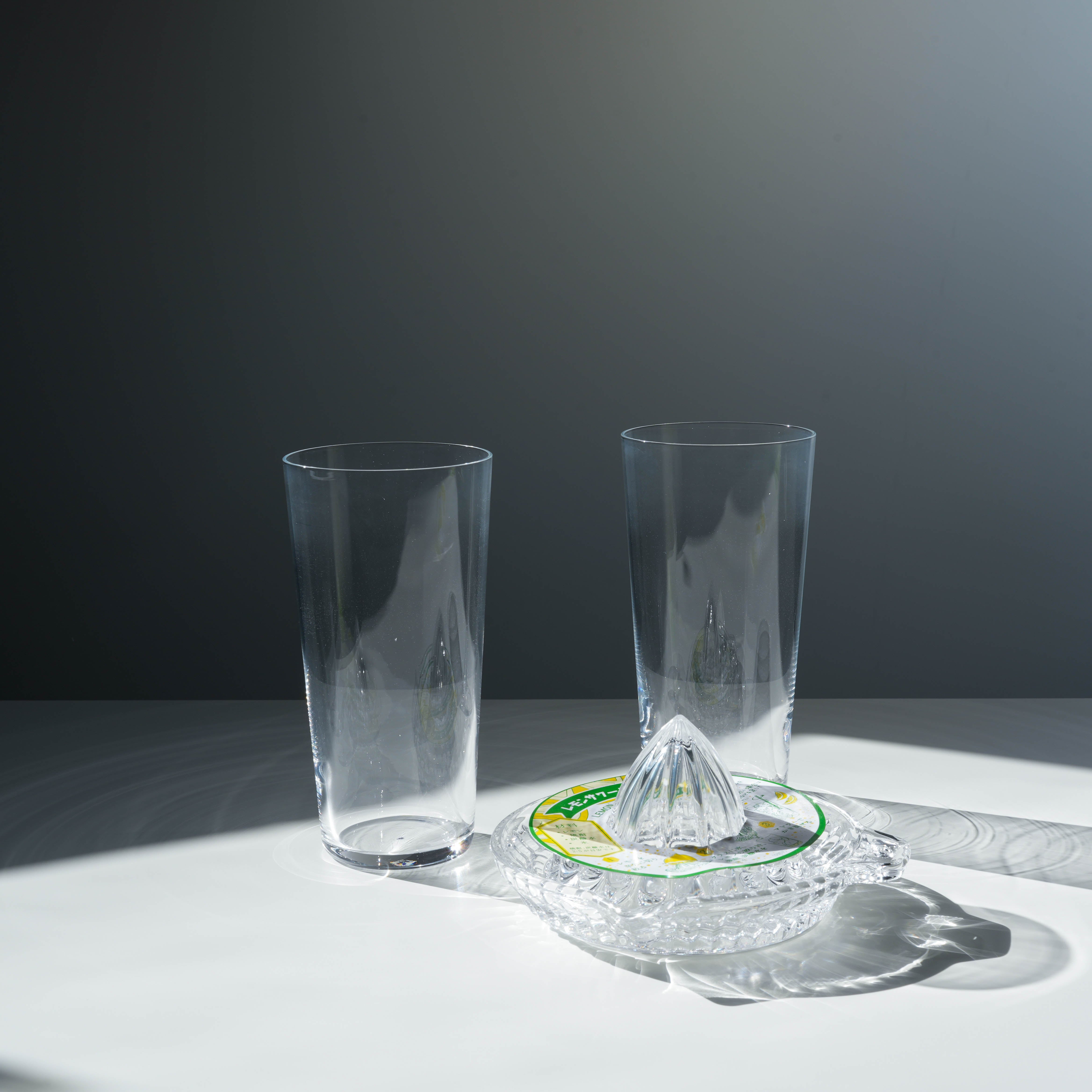 Elegant Toyo-Sasaki Lemonade Glass Set featuring two clear glasses and a glass citrus squeezer, perfect for home entertaining or gifting.