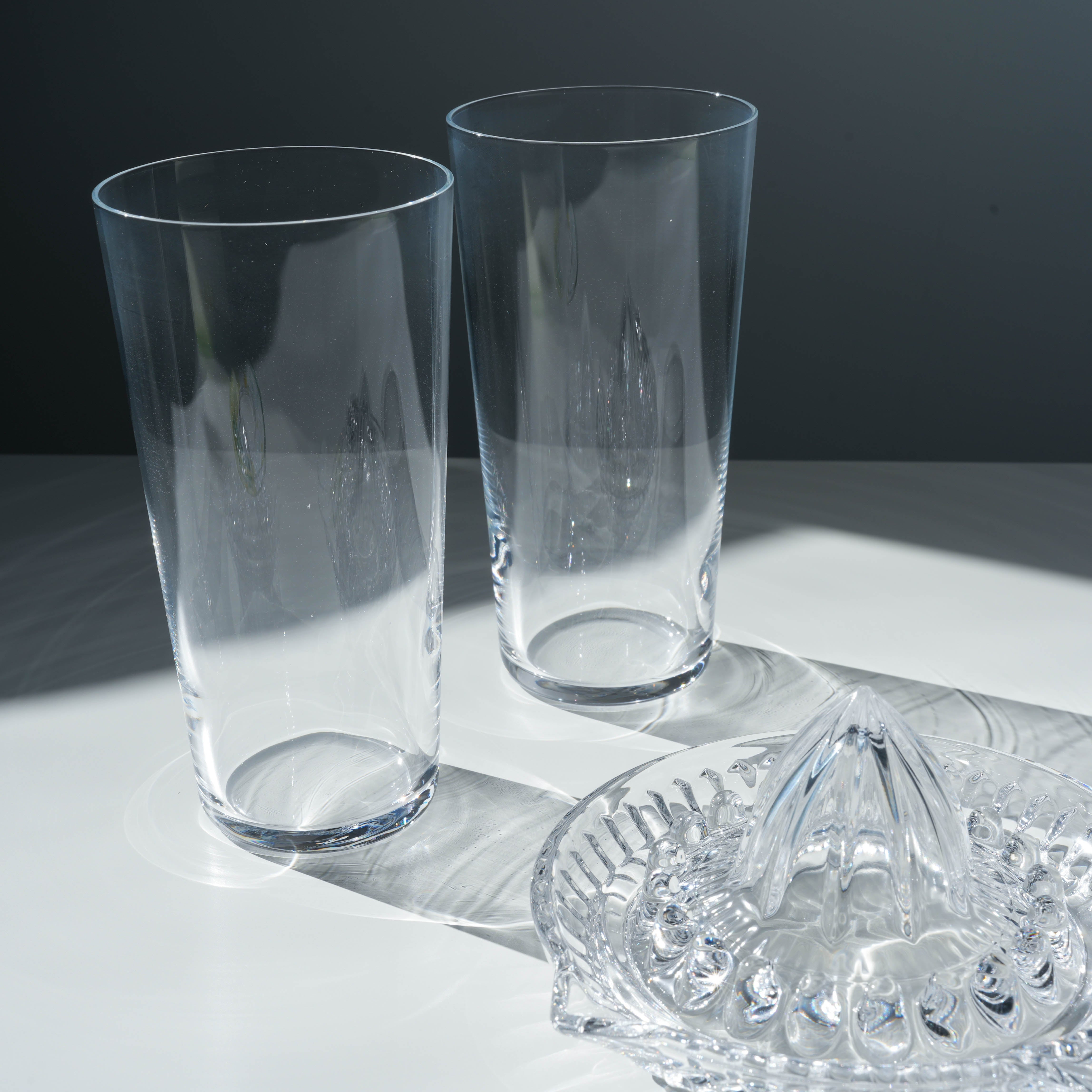 Close-up of Toyo-Sasaki Lemonade Glass Set showing fine craftsmanship of two clear glasses and a detailed citrus squeezer, made in Japan.