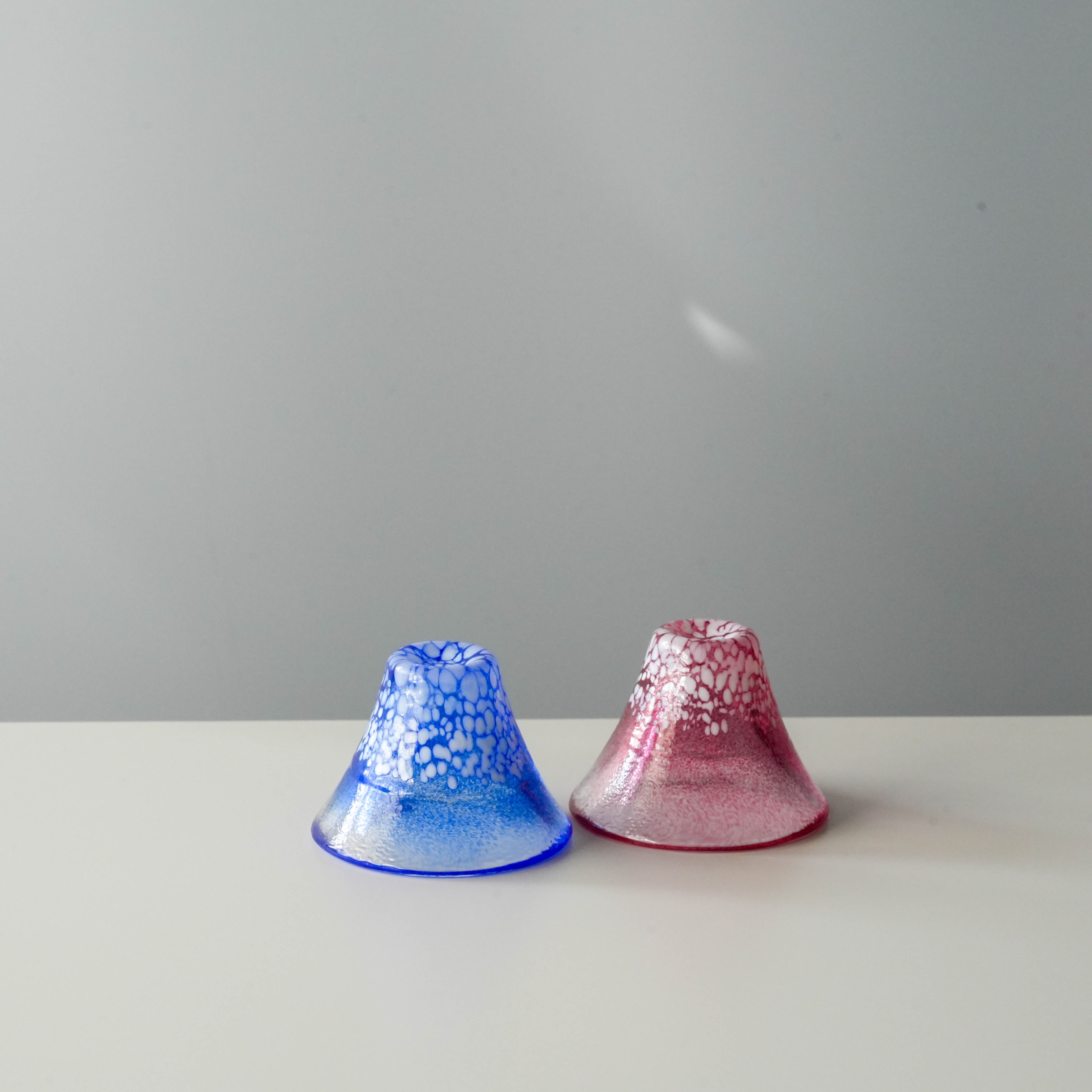 Fuji Sake Cup Set - Handmade Japan featuring Mt. Fuji-shaped blue and red glass cups, ideal for cold sake. Unique design for elegant drinkware.