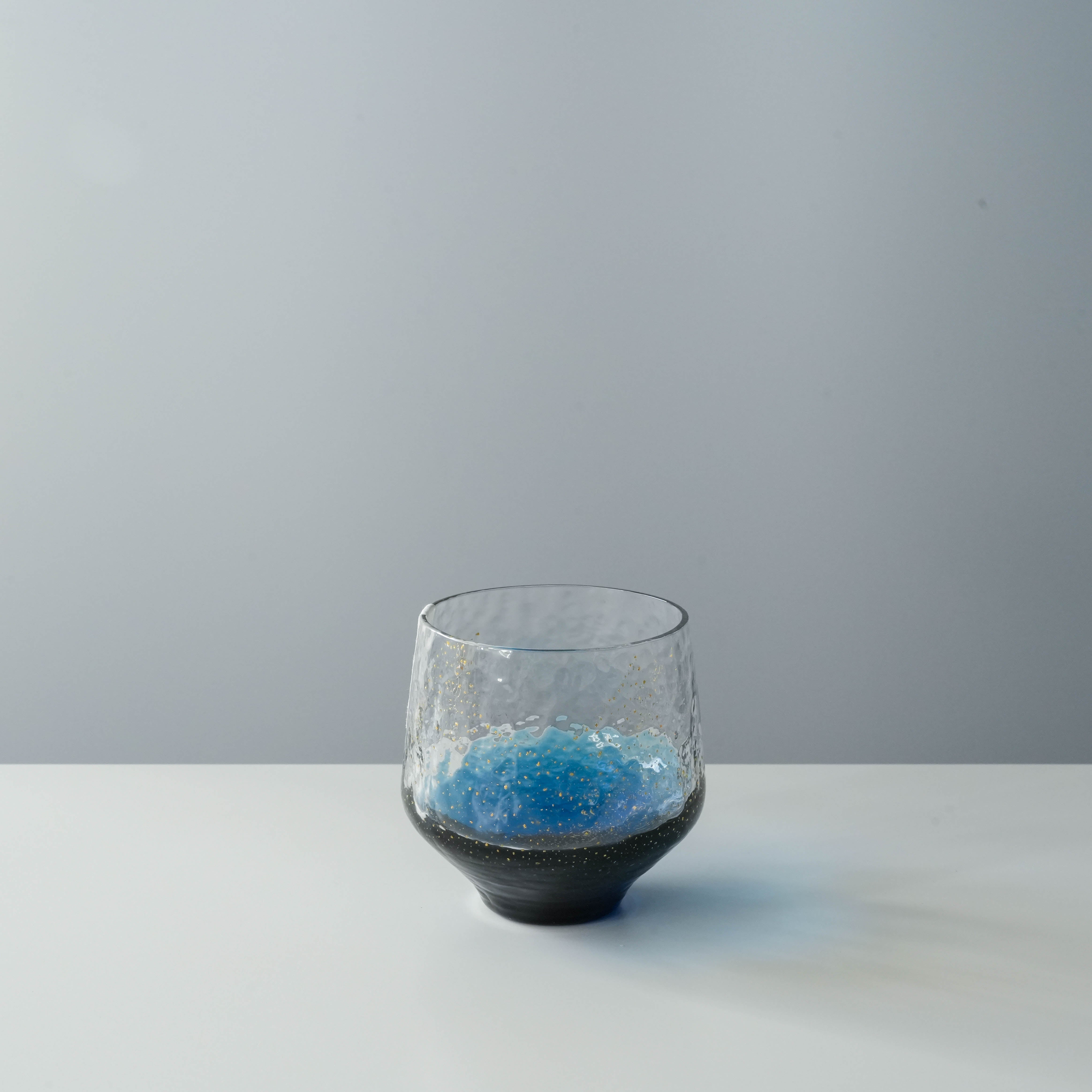 Toyo-Sasaki Sapphire Tumbler with blue base and golden sparkles, handcrafted Edo glass drinkware from Japan, ideal for gifting.
