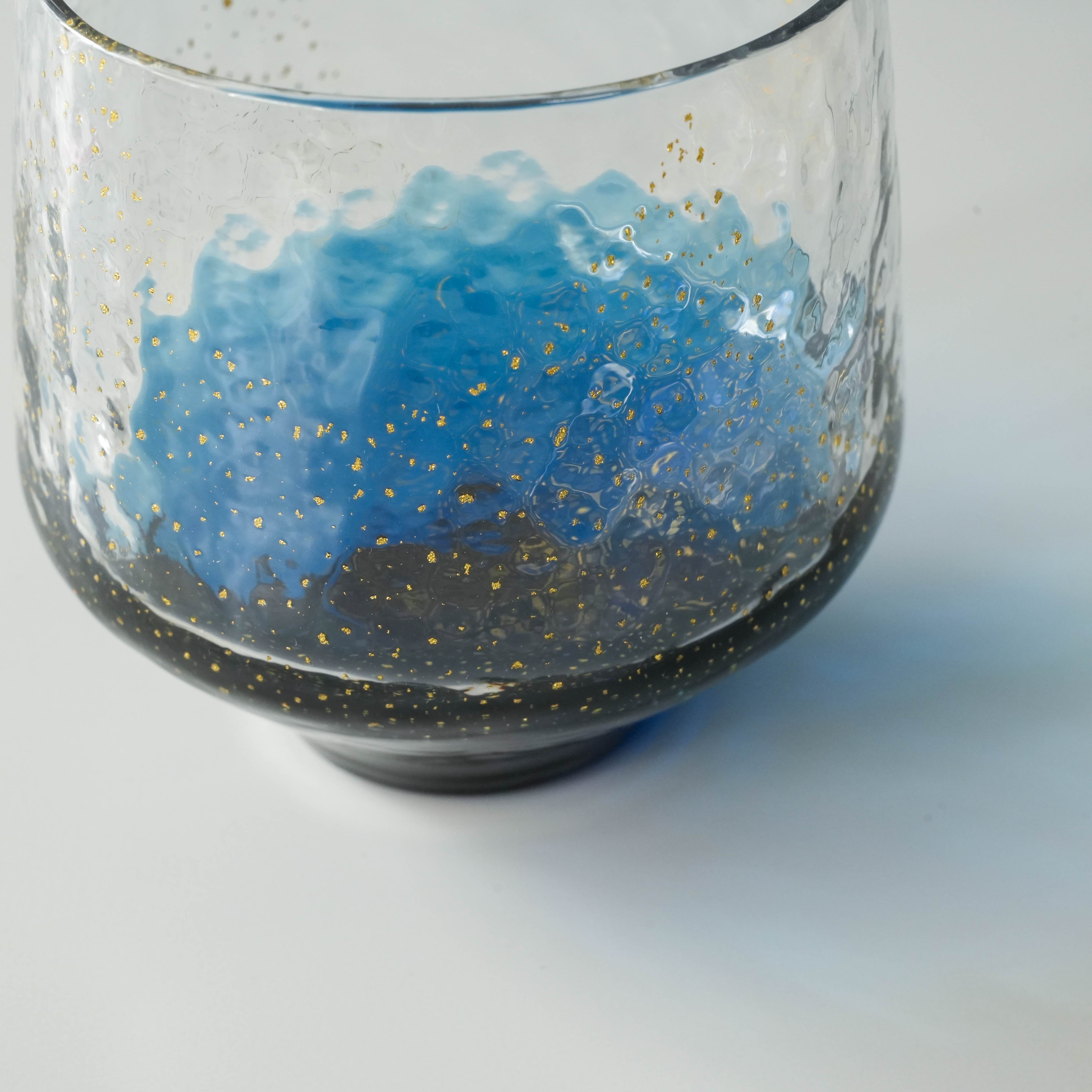 Detailed side view of Toyo-Sasaki Sapphire Tumbler highlighting textured glass, blue gradient, and gold accents.