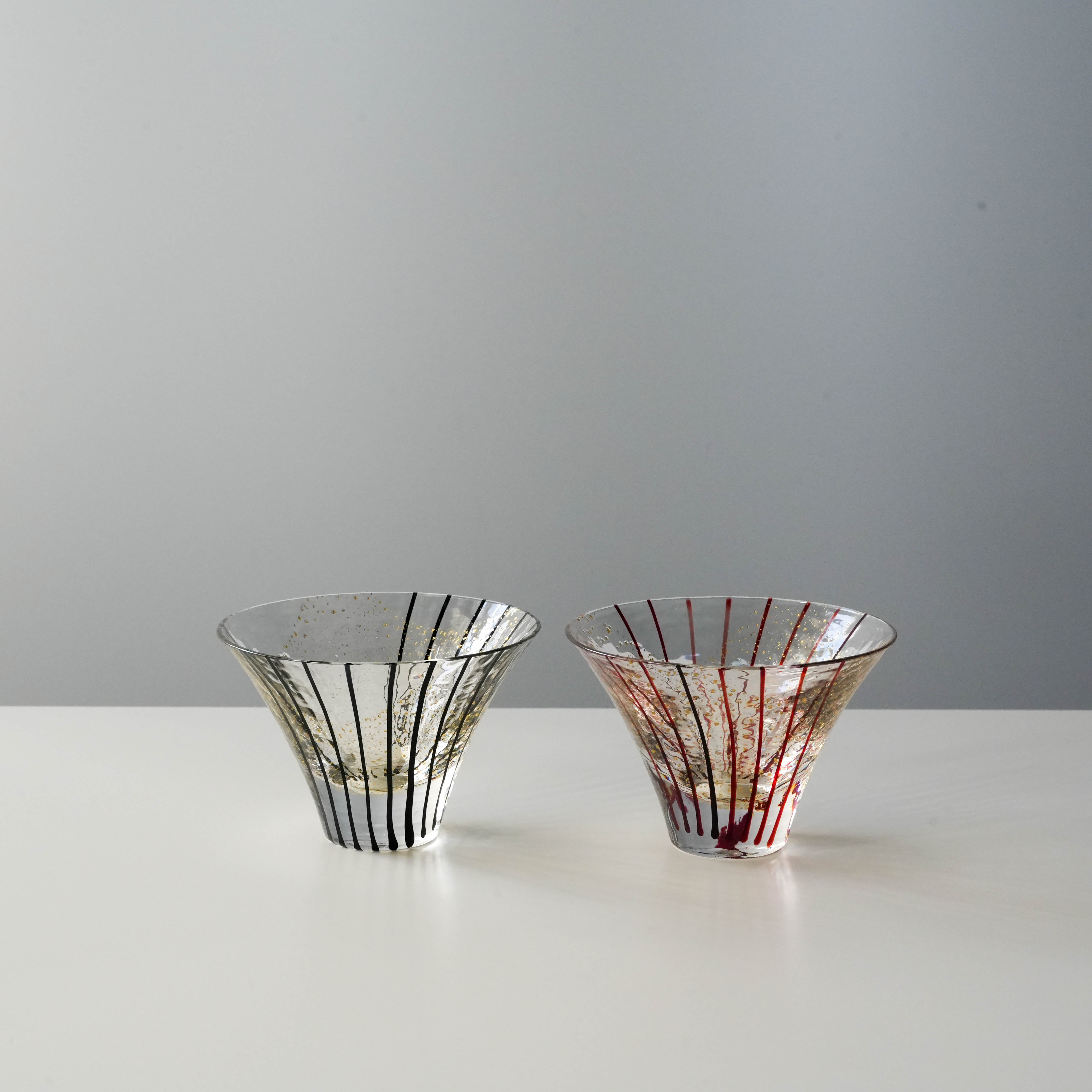 Set of 2 Toyo-Sasaki Edo Glass Sake Cups with vertical black and red lines. Premium Japanese tableware for refined dining experiences.