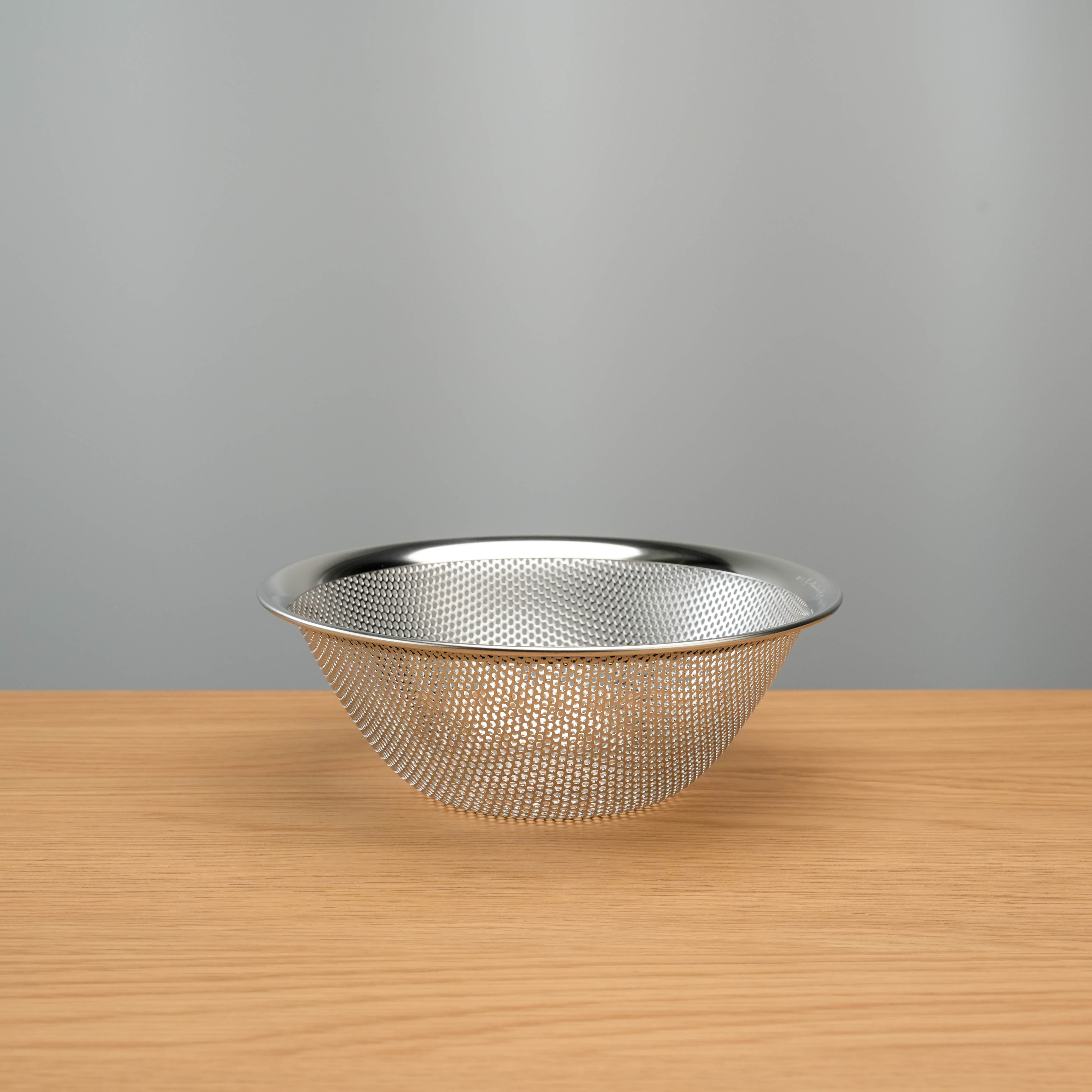 Sori Yanagi Stainless Steel Perforated Colander in minimalist Japanese design, ideal for rinsing and draining in modern kitchens.