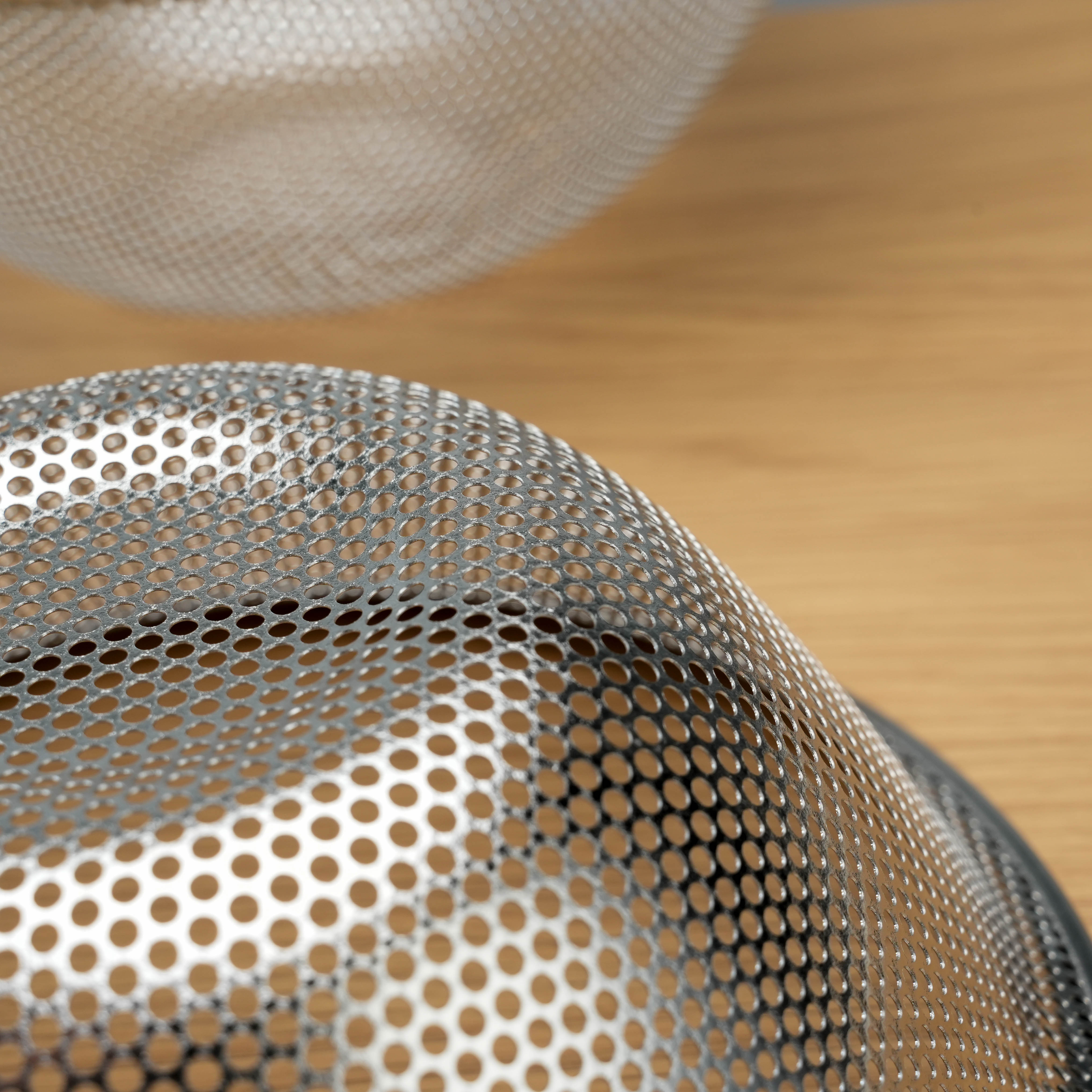 Detailed view of the perforated stainless steel mesh on the Sori Yanagi Colander, highlighting its lightweight and durable build.