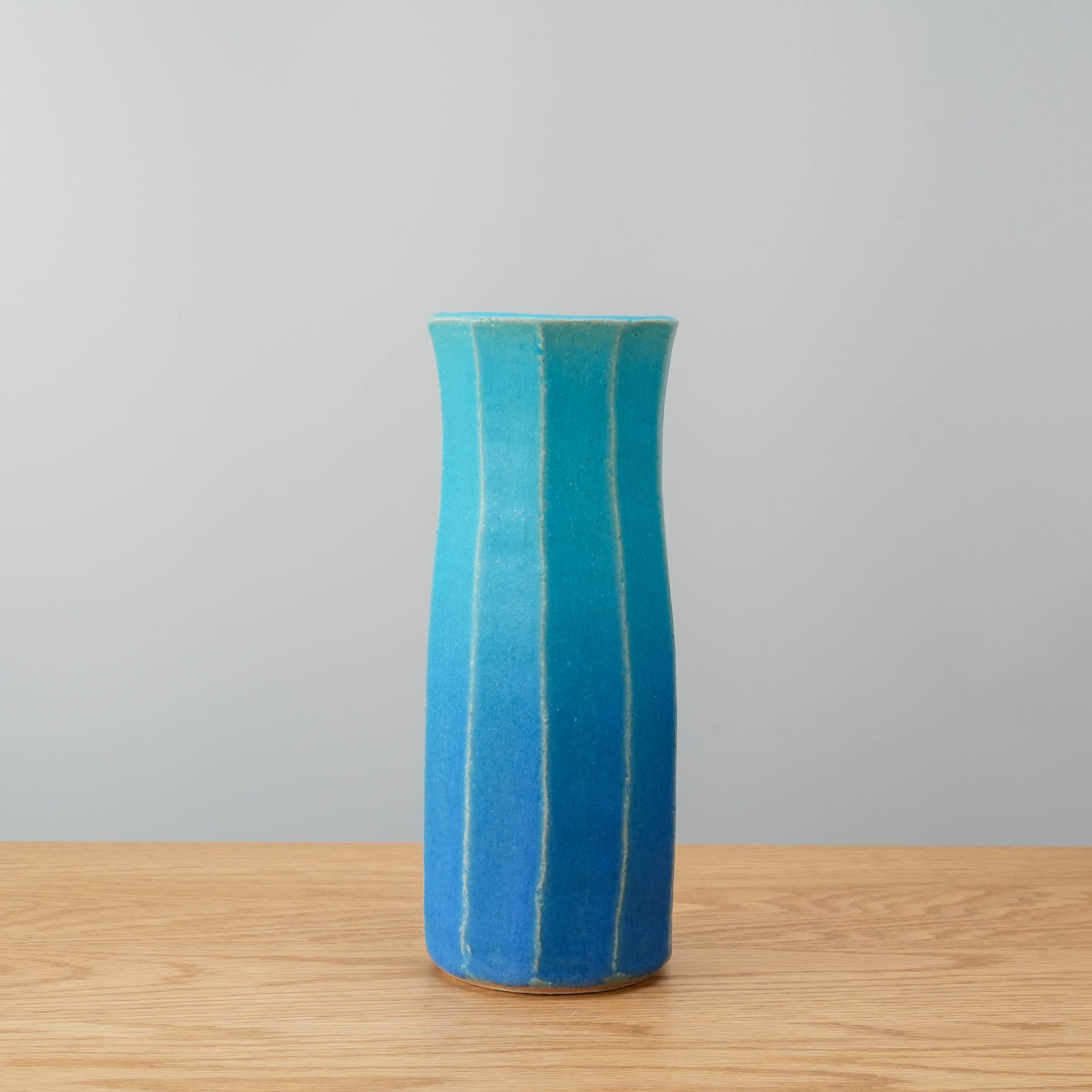 Shigaraki Flower Vase in gradient blue ceramic from Shisui Kiln, featuring vertical ridges and a tall, elegant form for floral arrangements.