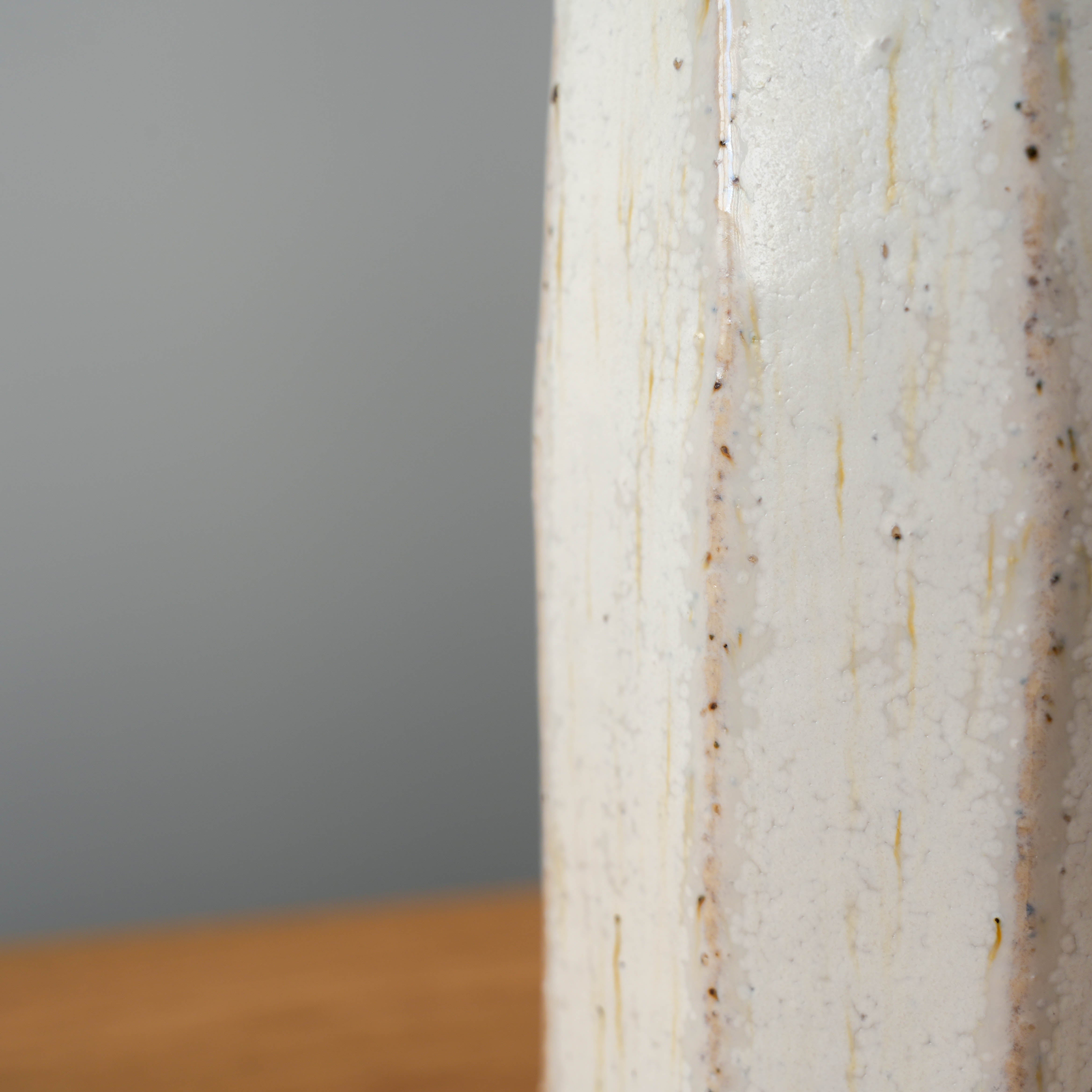 Detail of white Shigaraki Flower Vase from Shisui Kiln, featuring speckled ash glaze and natural vertical striations.