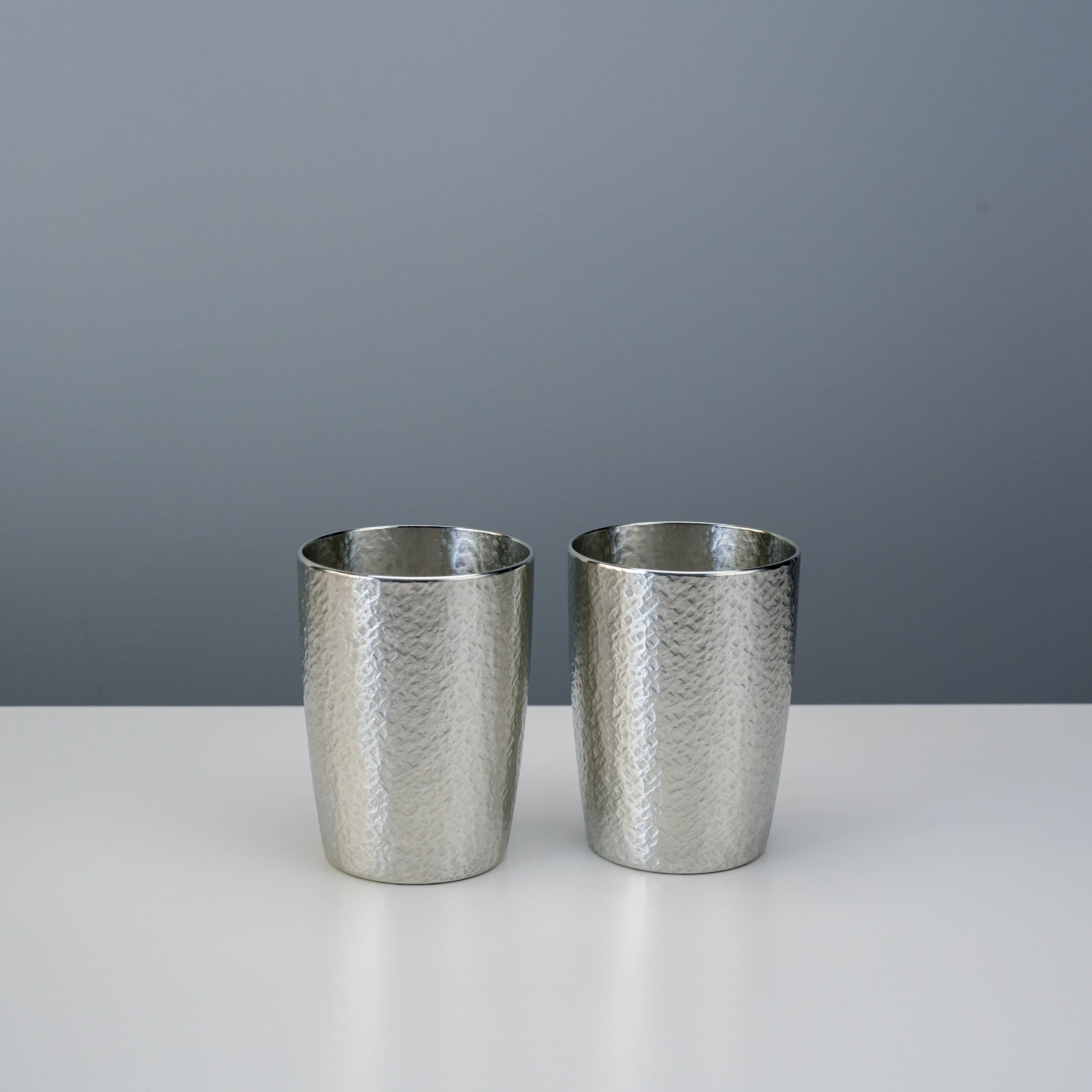 Osaka Tinware Tumbler Set - Tin Tumbler | Pure Tin, 2pc shows a pair of handcrafted tin tumblers with a hammered surface, ideal for stylish drink service.