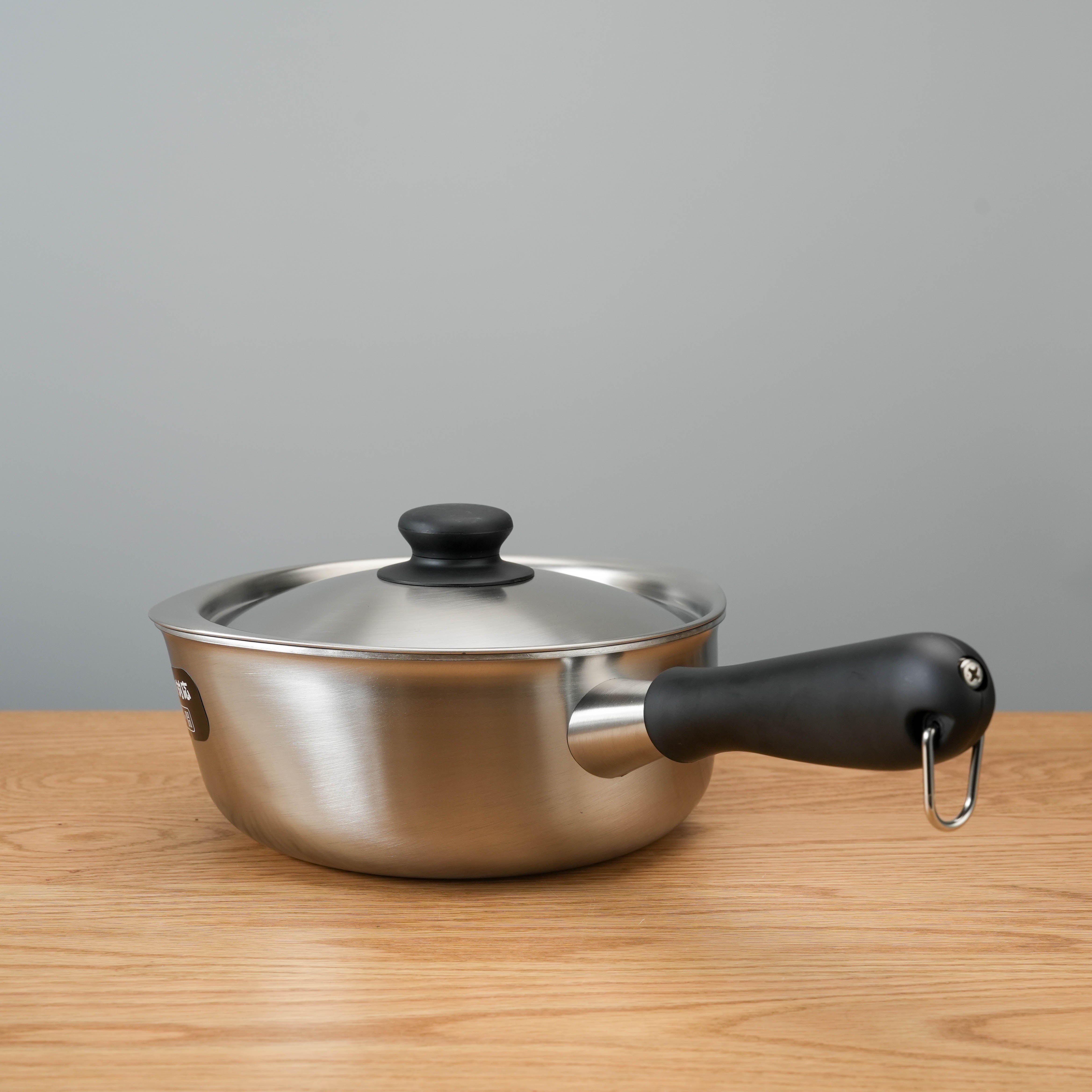 Side profile of Sori Yanagi Stainless Steel Induction Saucepan featuring a durable black handle and sleek Japanese craftsmanship.