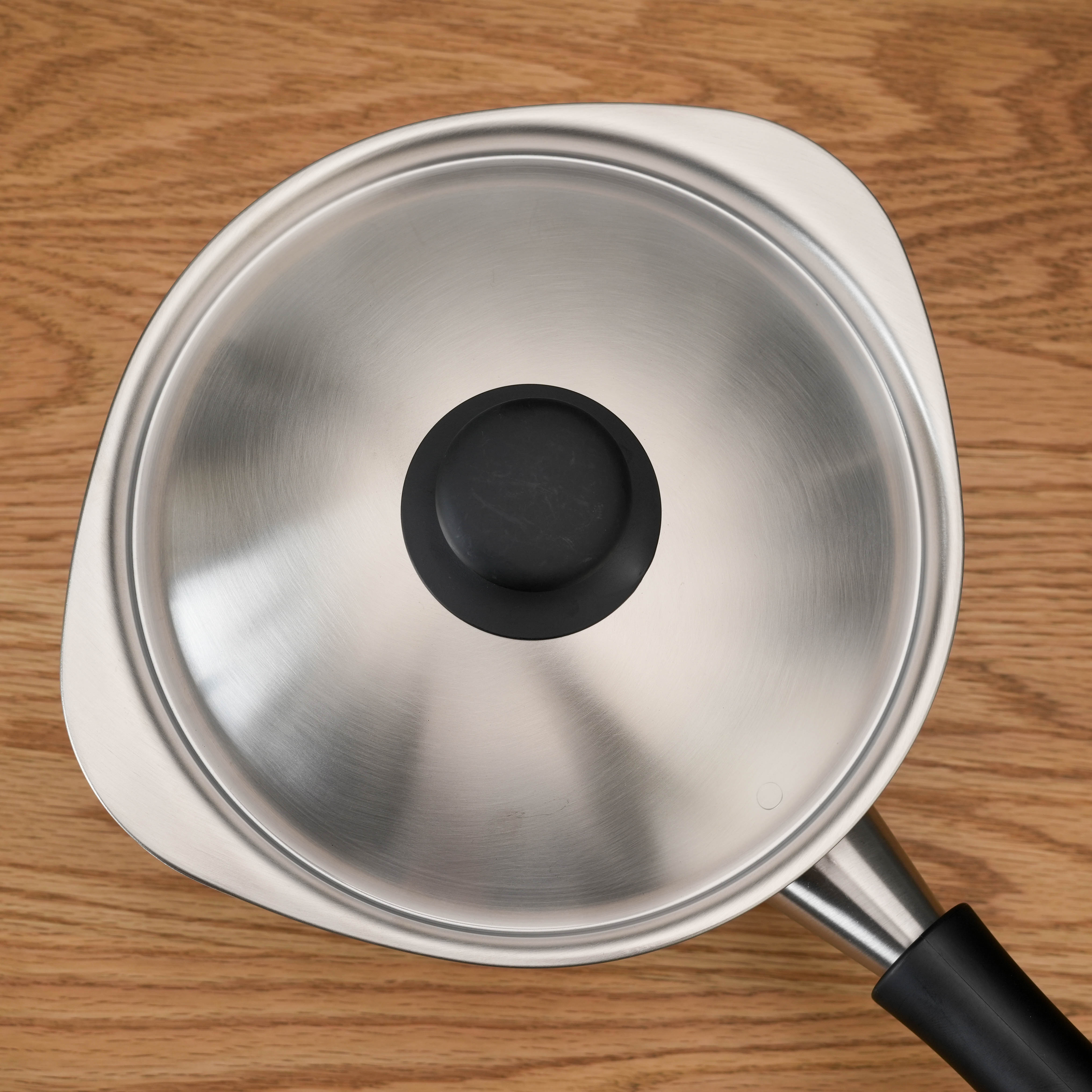 Top view of Sori Yanagi Induction Saucepan with lid, showcasing its unique triangular spout design for easy pouring.