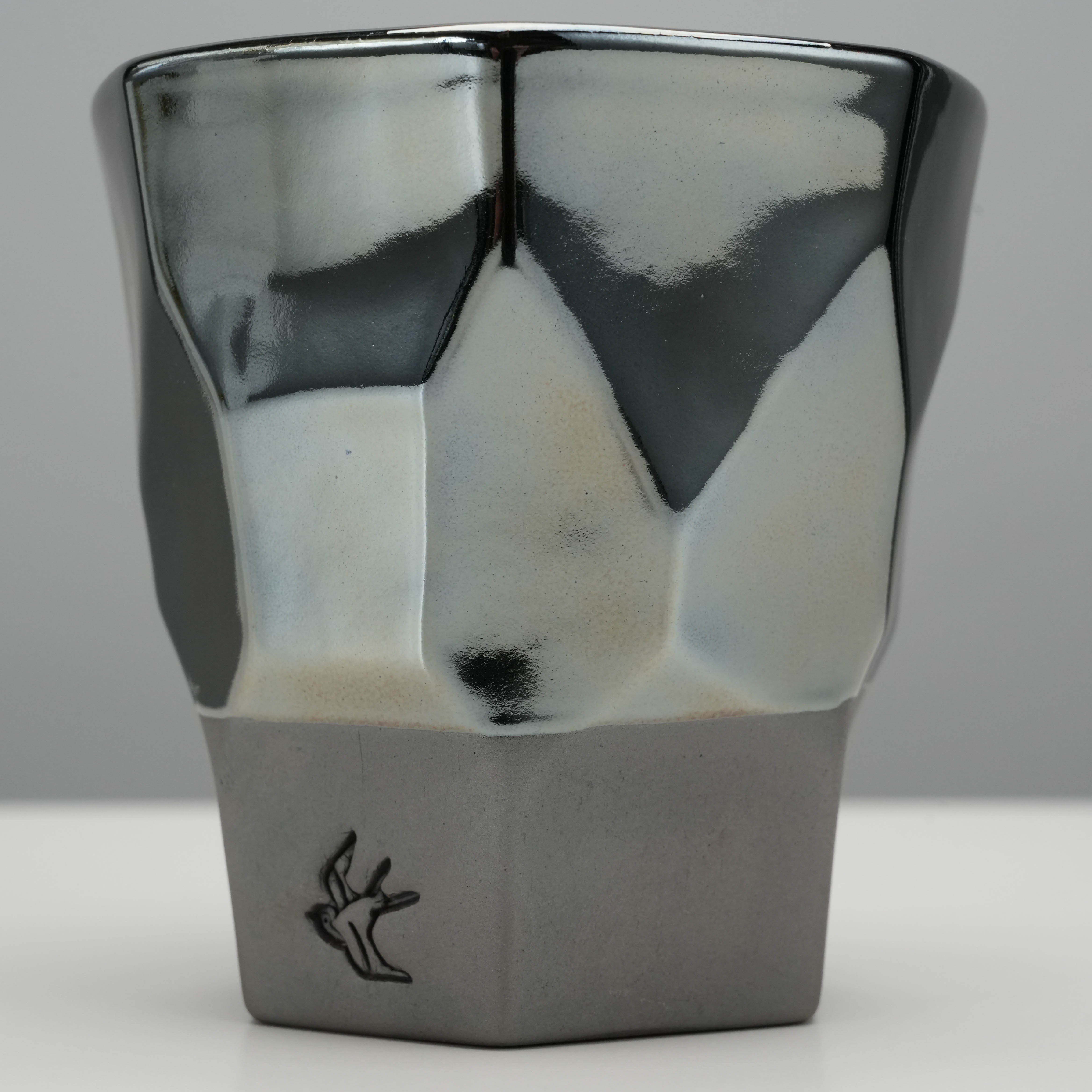 Side view of Tsubame Kobo Free Cup - Tumbler showcasing its geometric shape and smooth gradient from platinum to black clay.