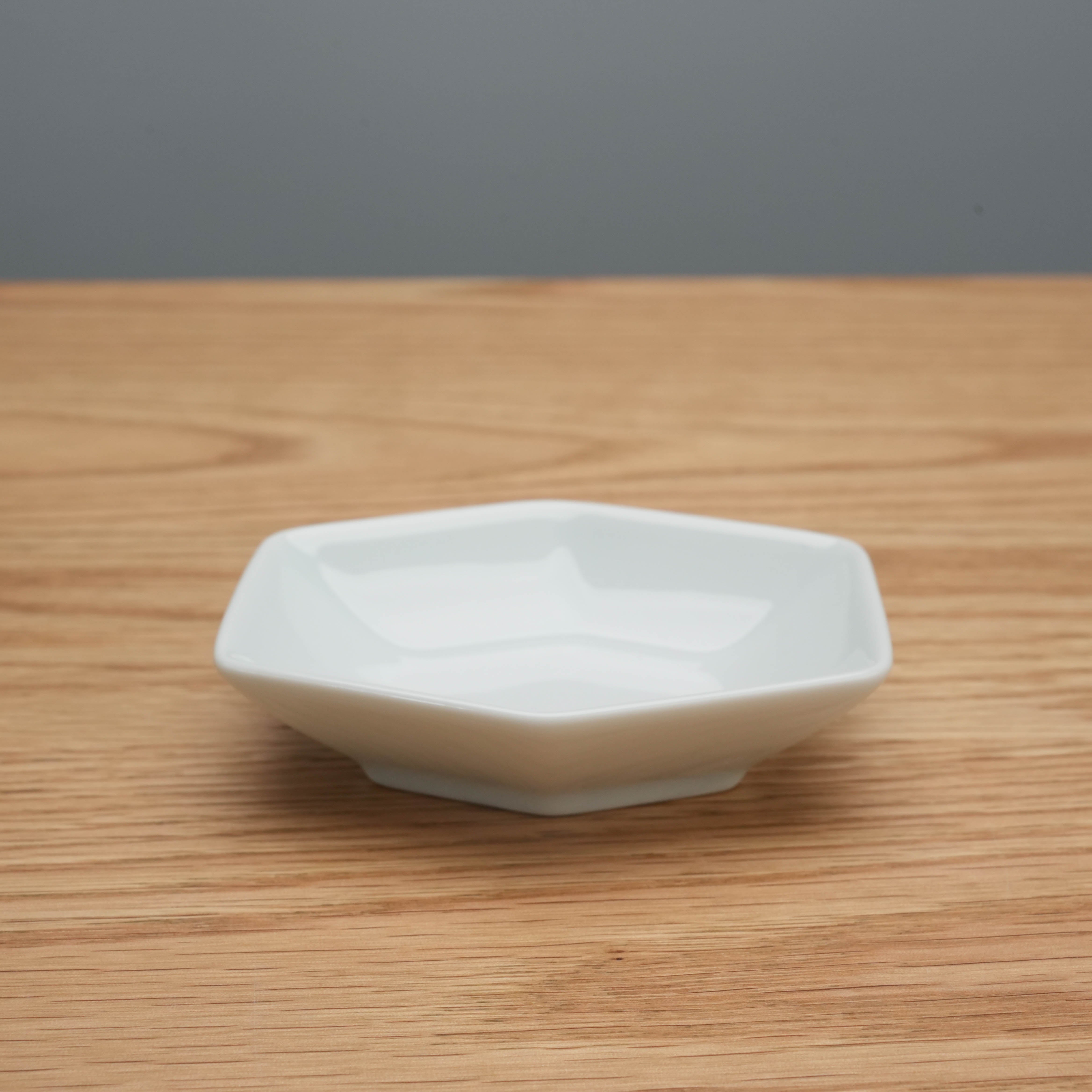 White Hasami ware Hakusan Kikkou Sauce Dish featuring a modern hexagonal form, suitable for serving sauces or small bites.